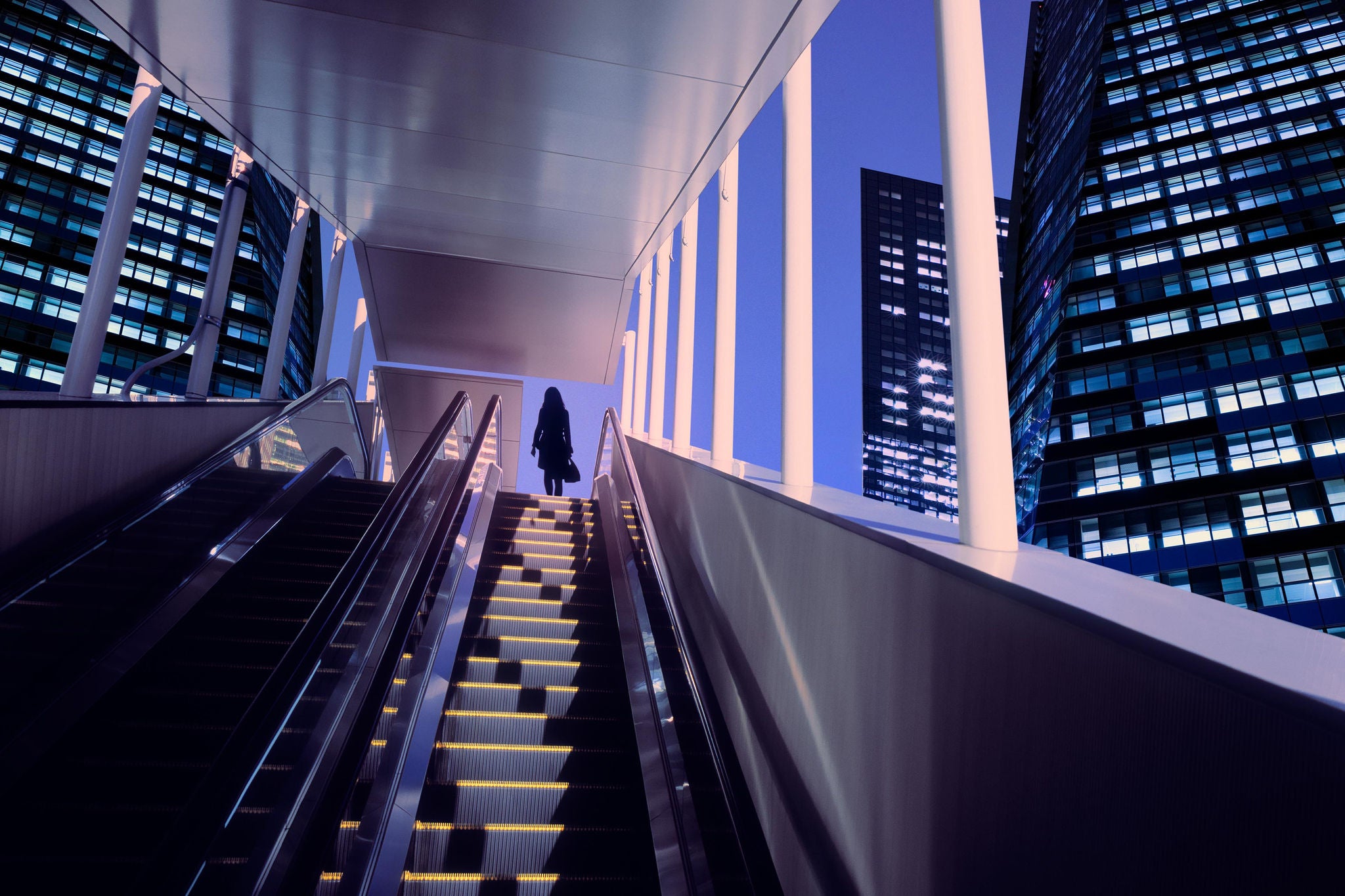 Businesswoman on top of moving escalator