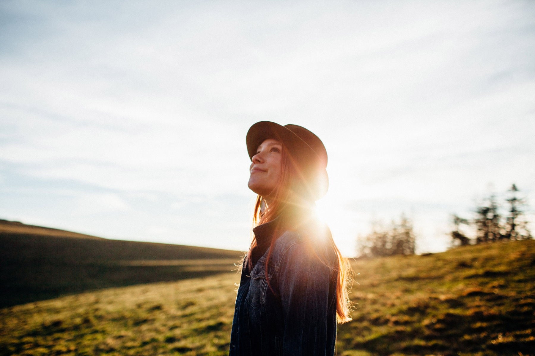 Girl with hat looking upward