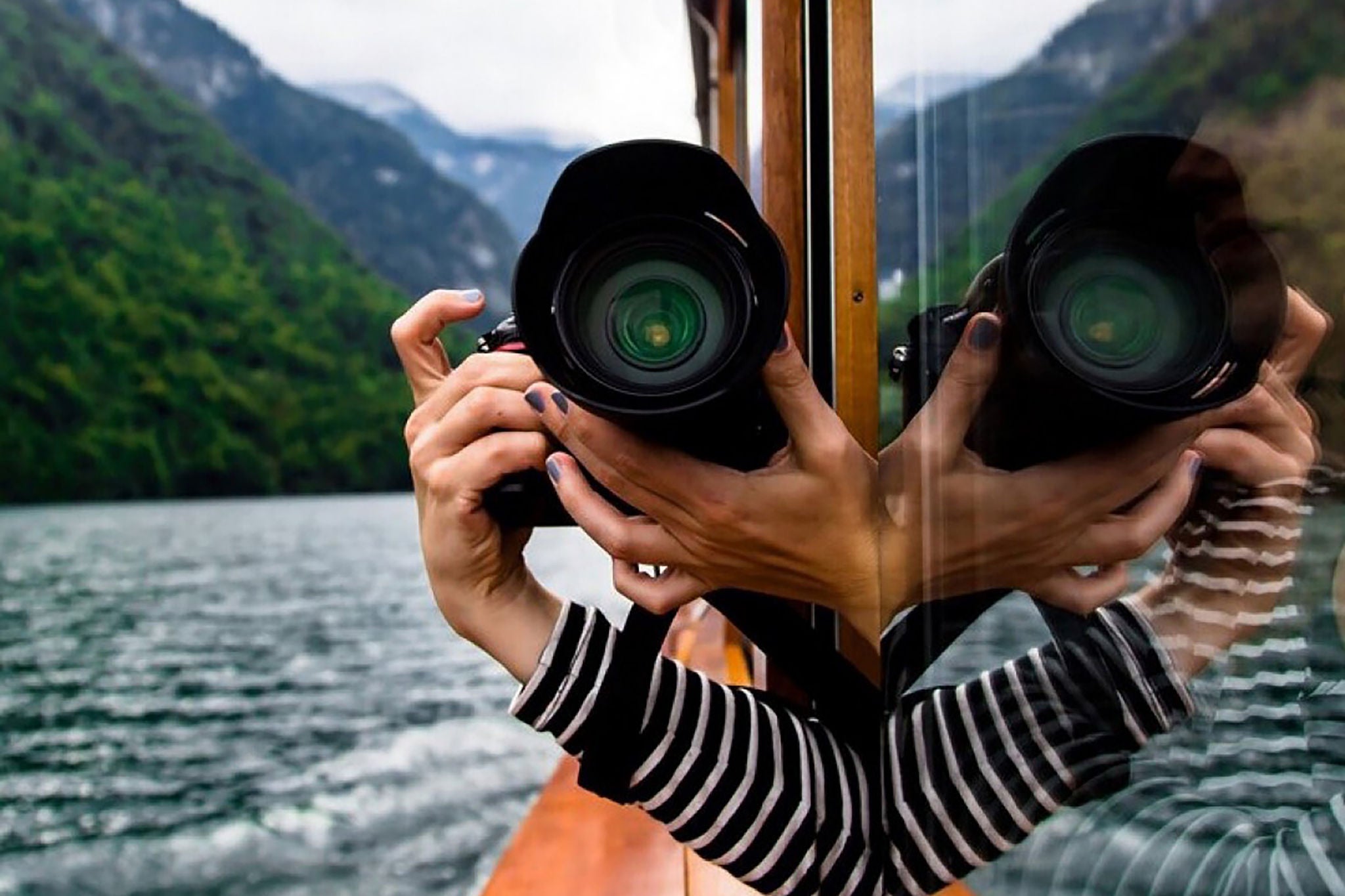 Person holding camera out in Boat