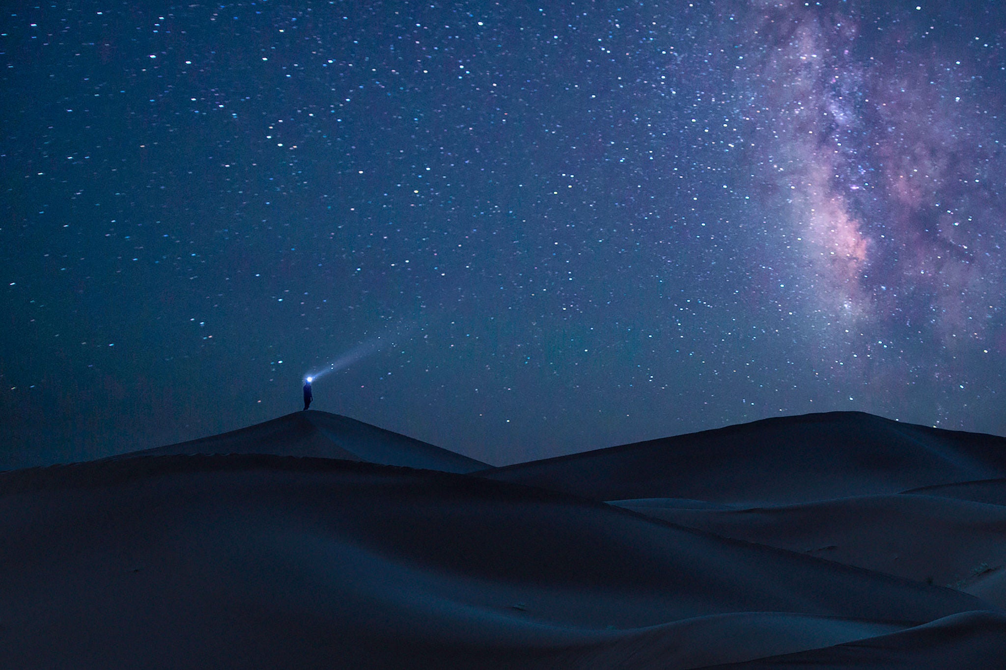 Alone man under the Milky Way, Sahara desert, Morocco.