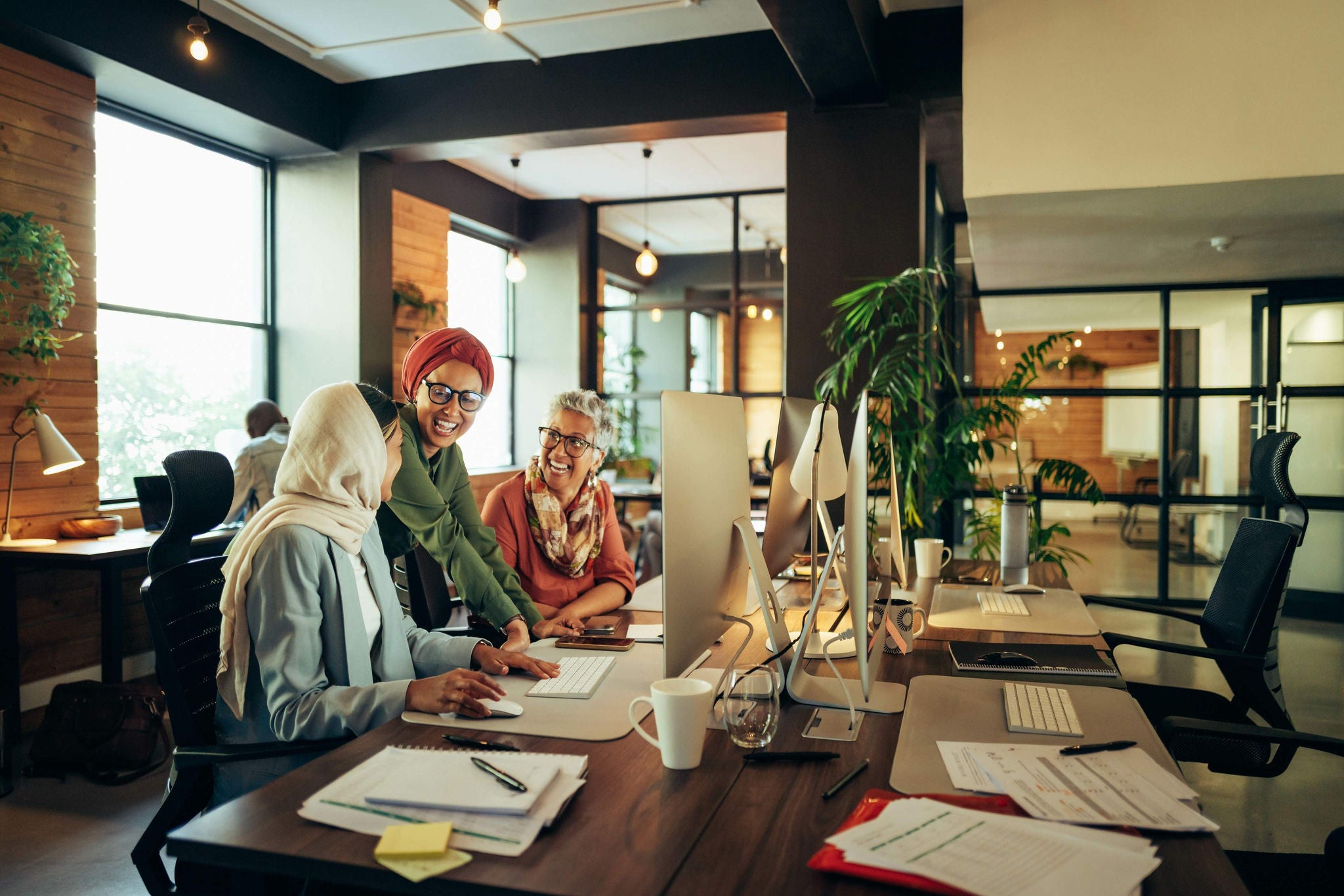 Happy businesswomen working together in a modern co-working office