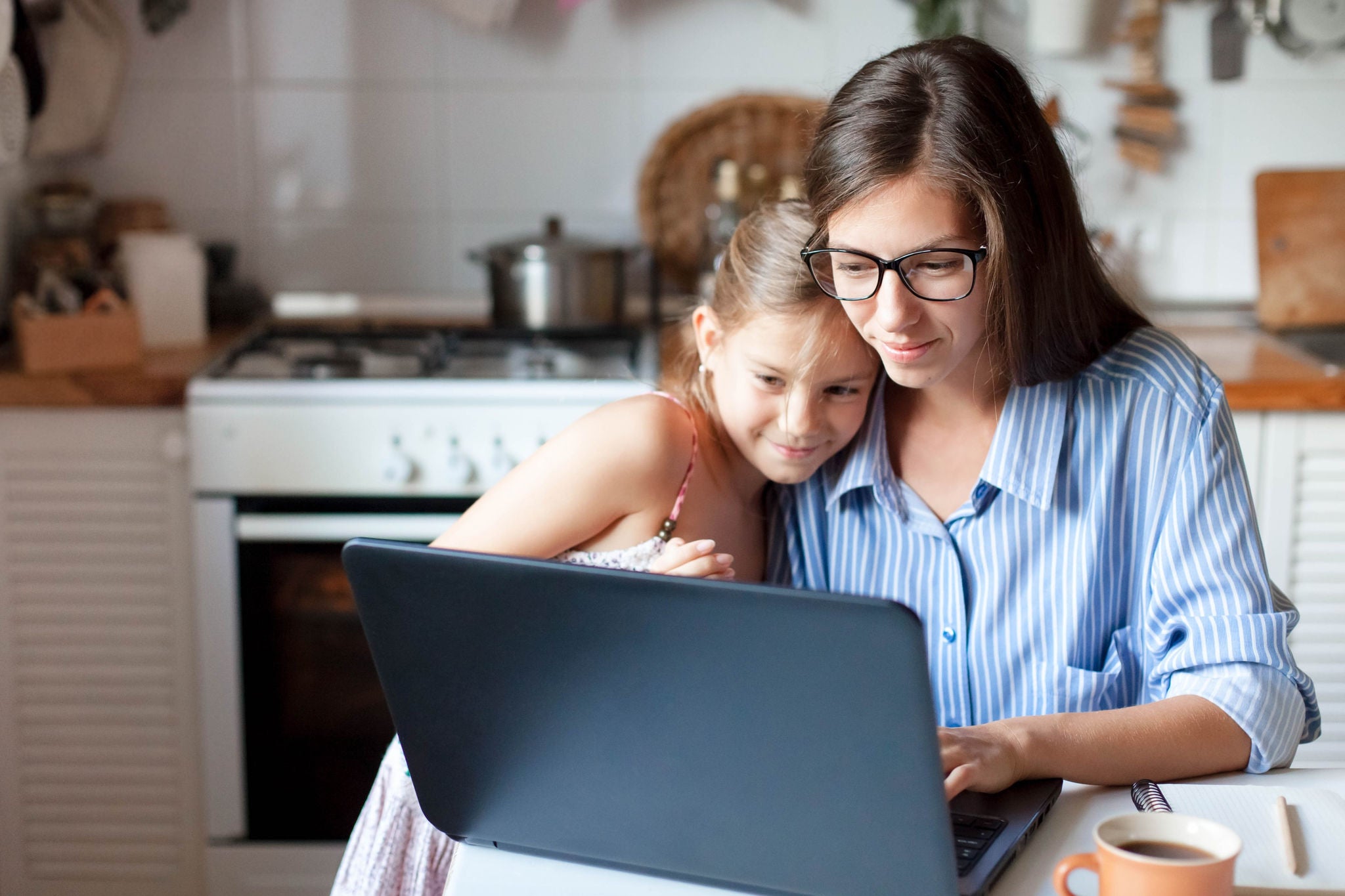 Women and daughter looking into laptop