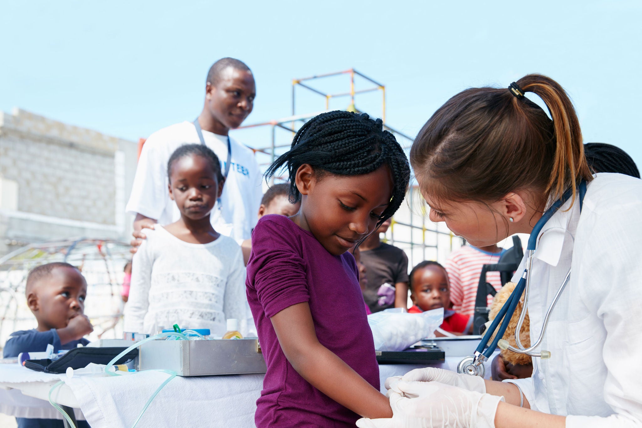 Young girl getting a vaccination from a doctor