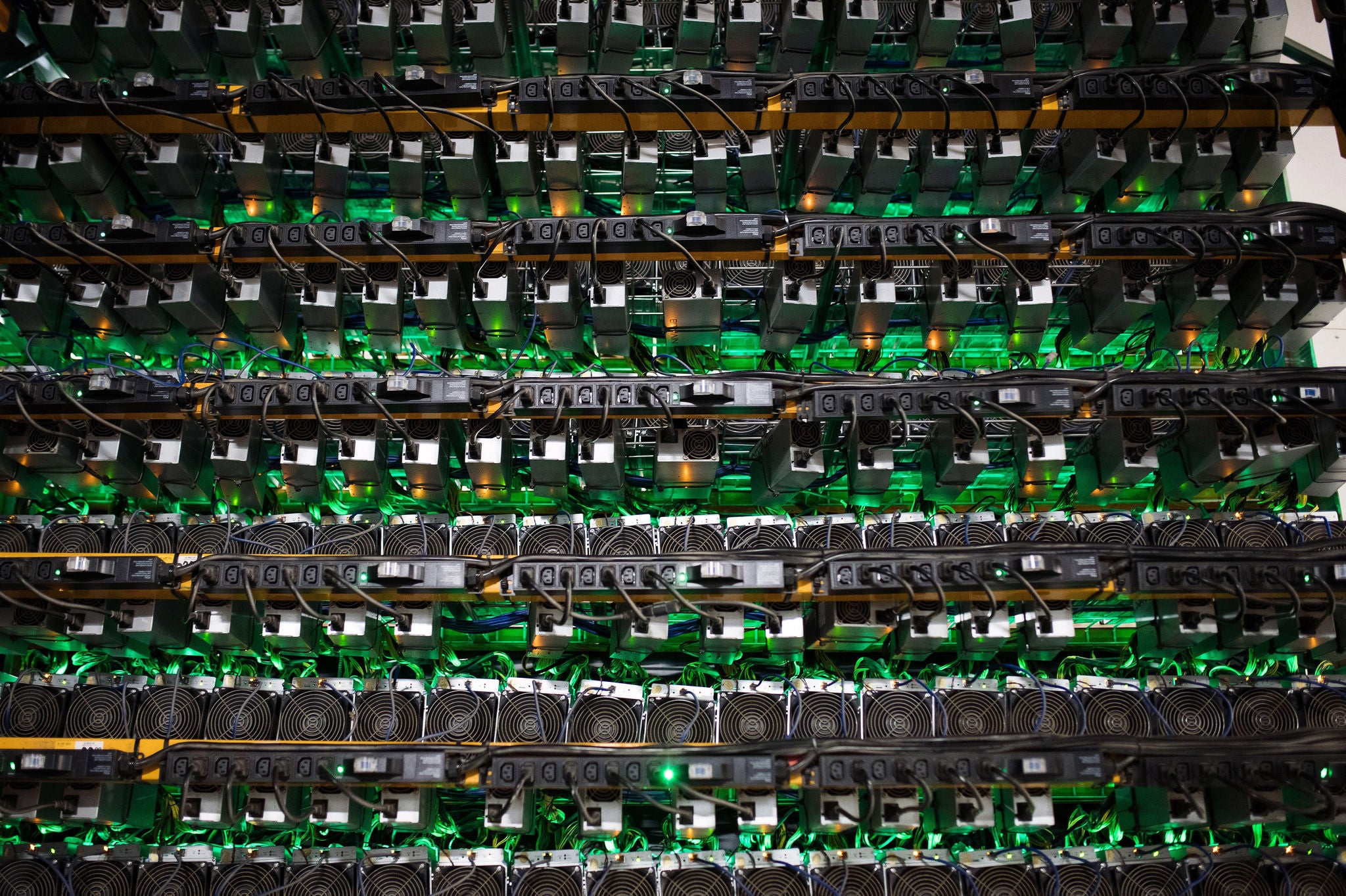 Cryptocurrency mining rigs sit on racks