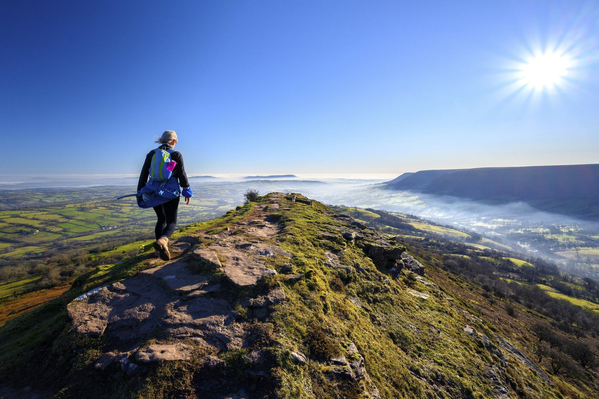 Person walking on top of mountain