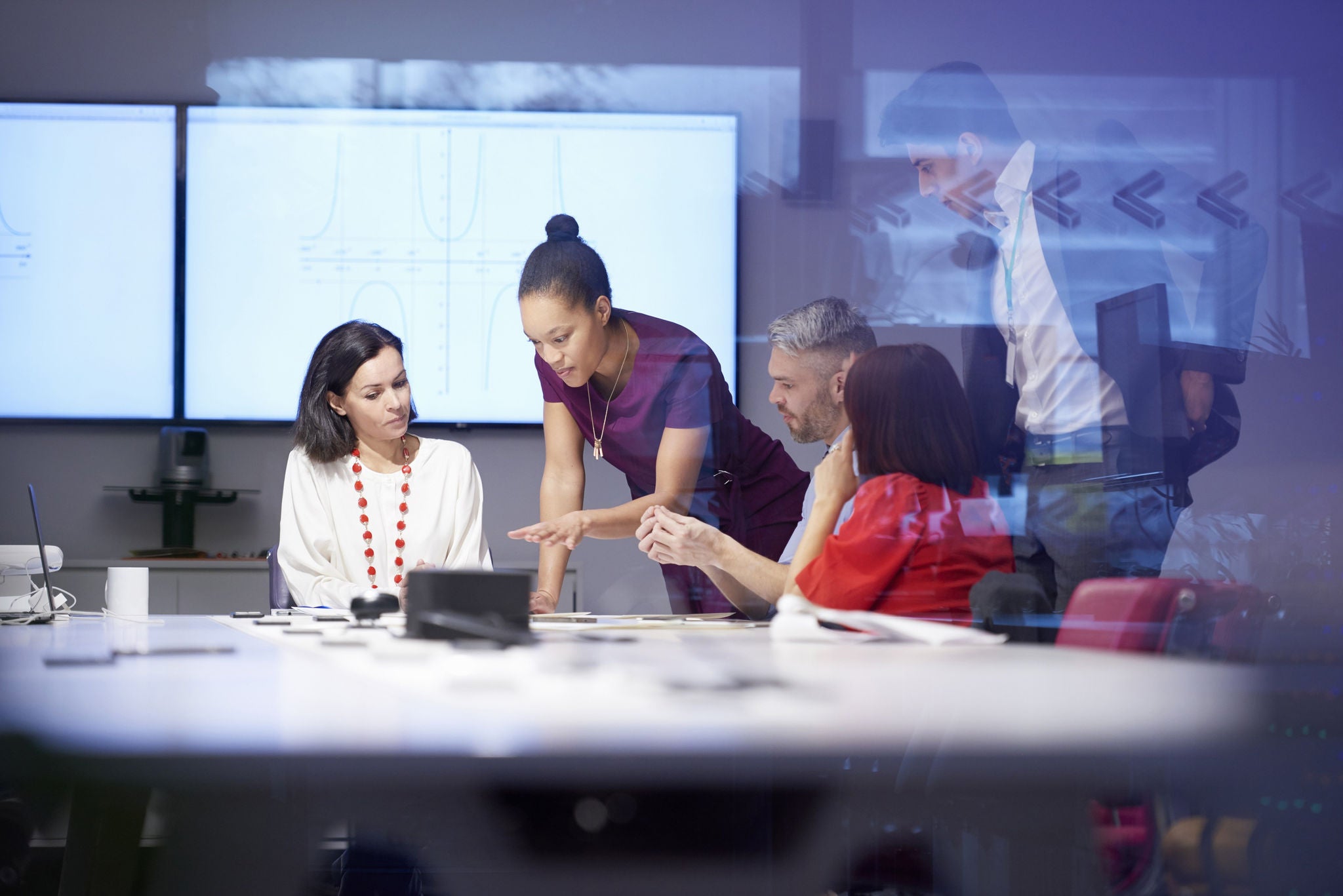 A team is discussing in meeting room 