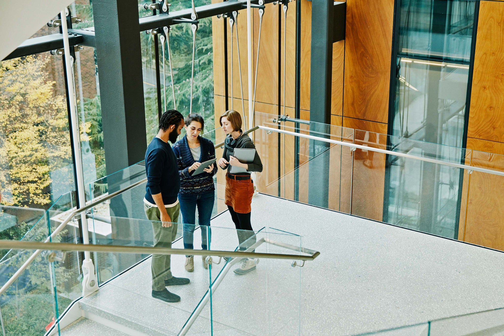 Coworkers discussing data on digital tablet in office