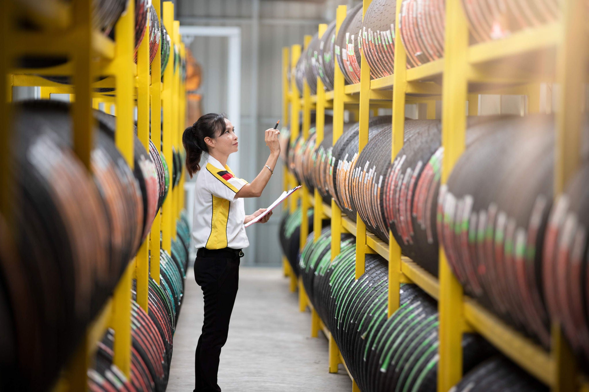 Woman in warehouse counting products