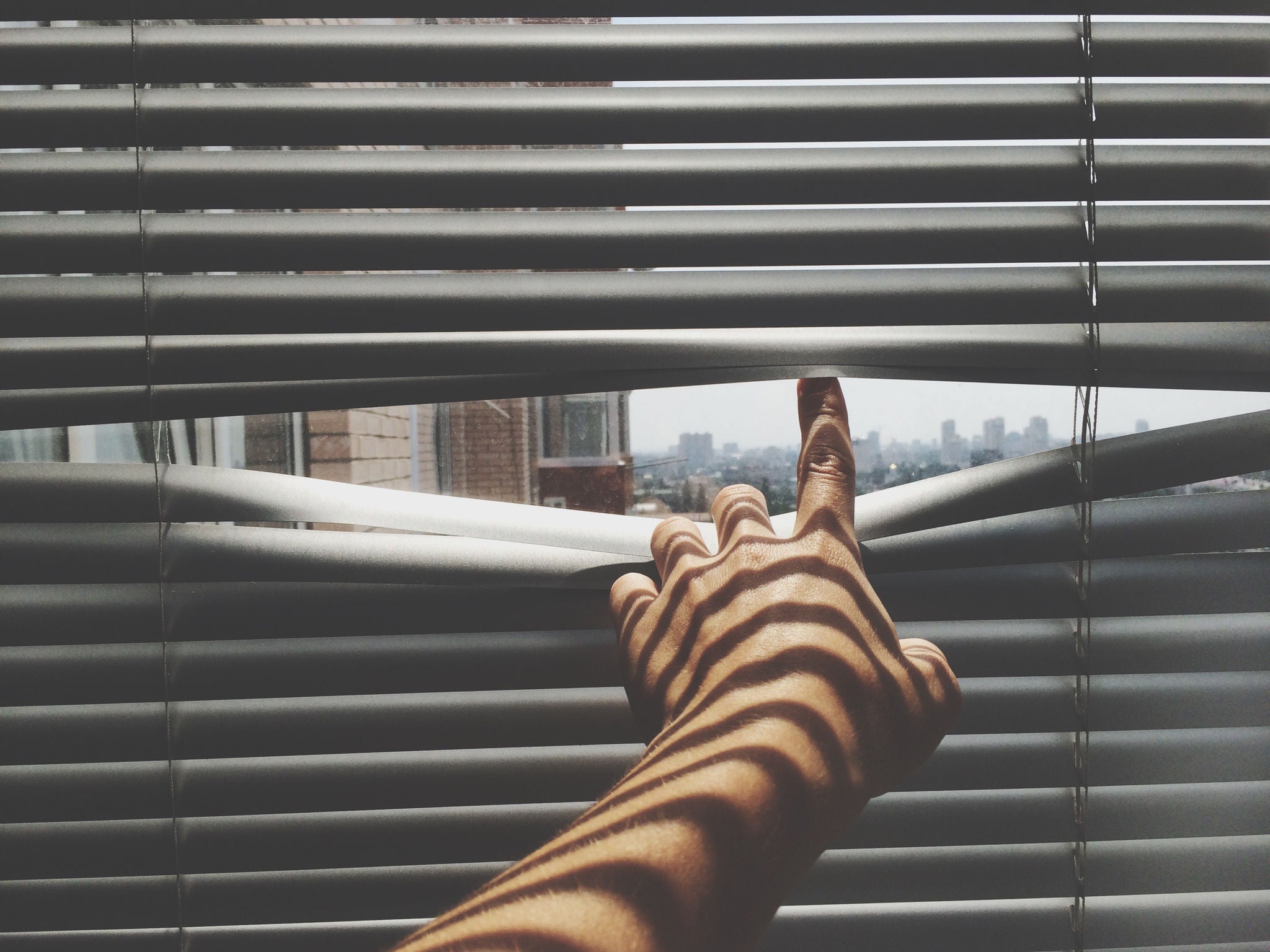 Close-Up Of Person Looking Through The Window