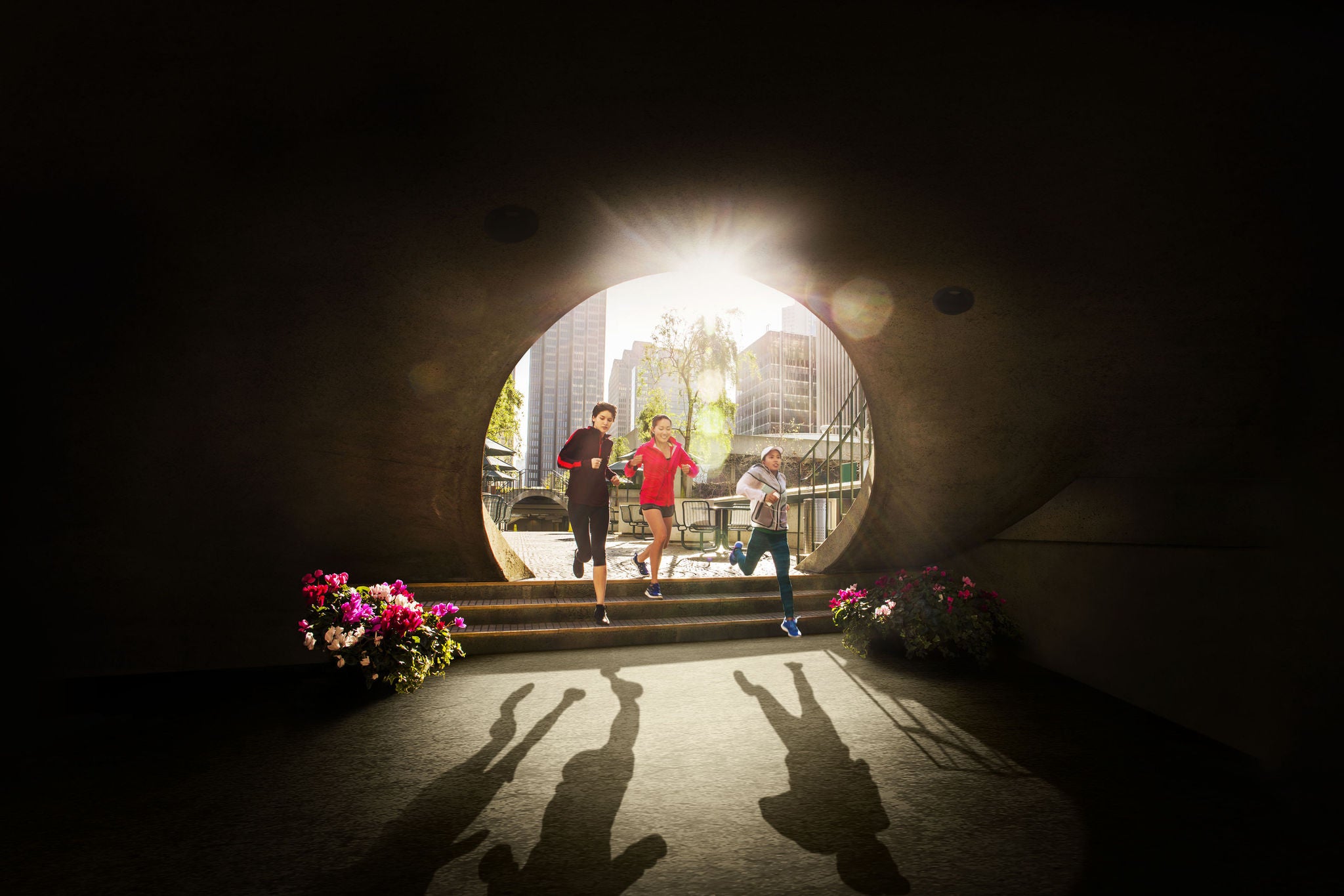 Mulheres correndo pelo arco de um parque urbano