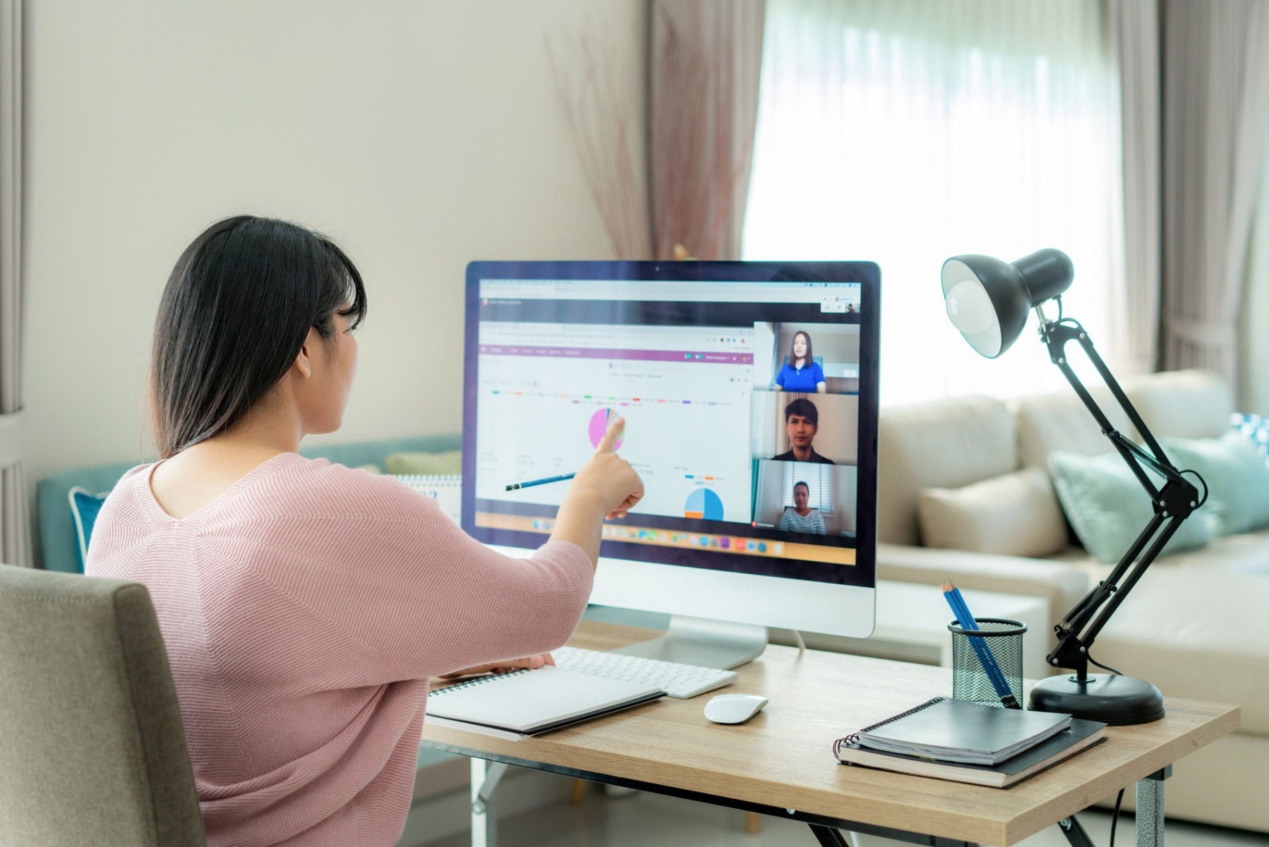 Woman explaining the pie chart in online meeting