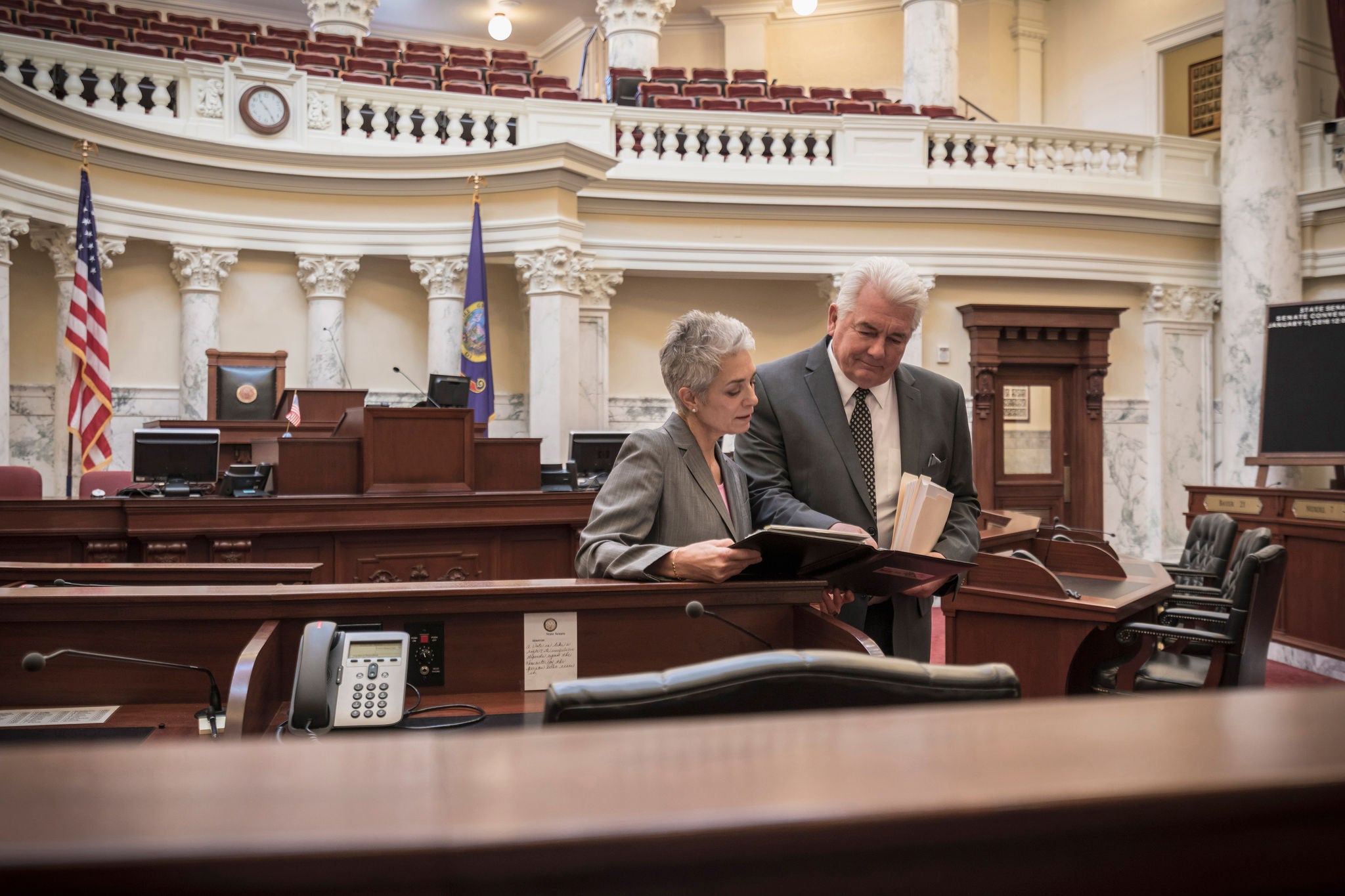 politicians reviewing documents in capitol building