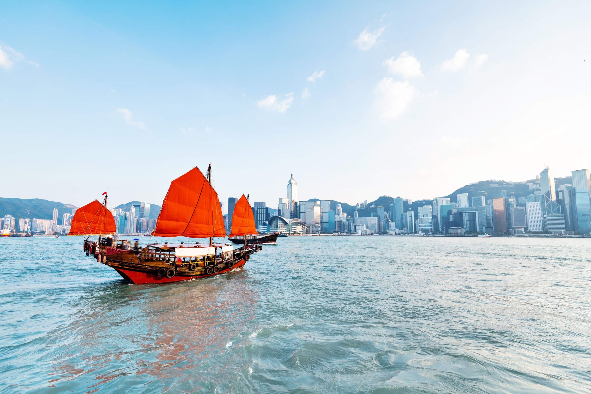 Junk boat crossing Hong Kong harbor.