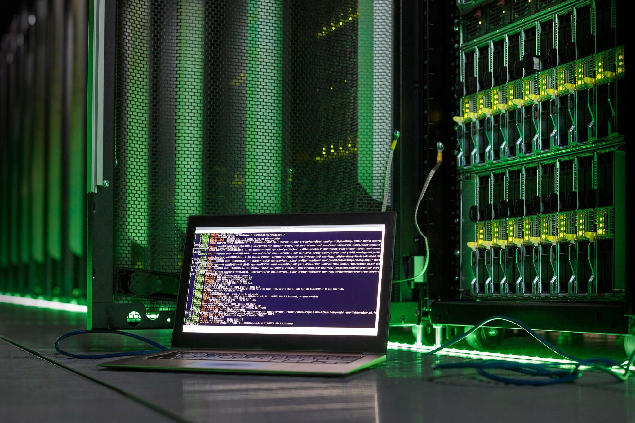 Laptop with computer language in server room