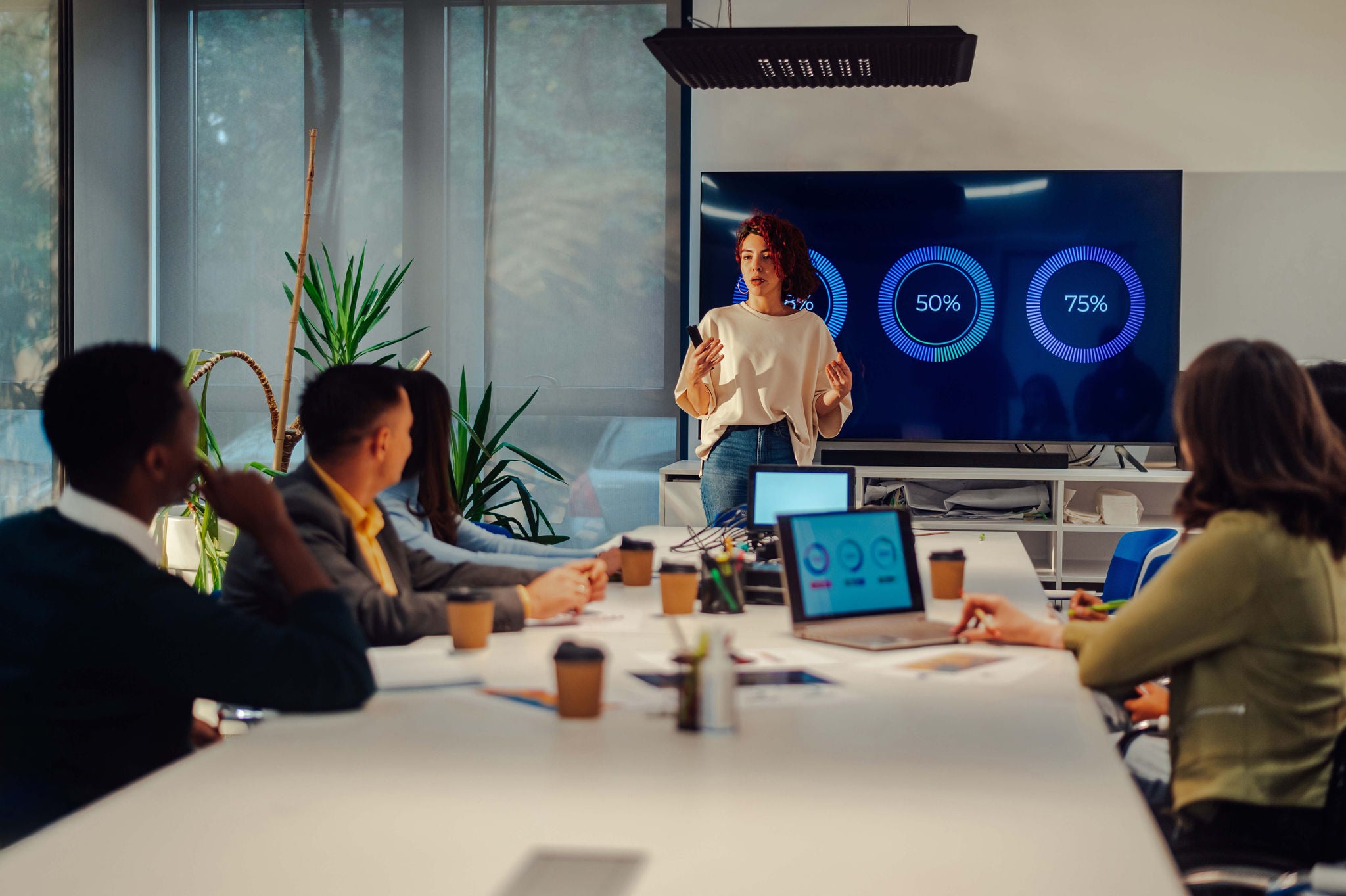 Hispanic woman boss holding a meeting in a modern office