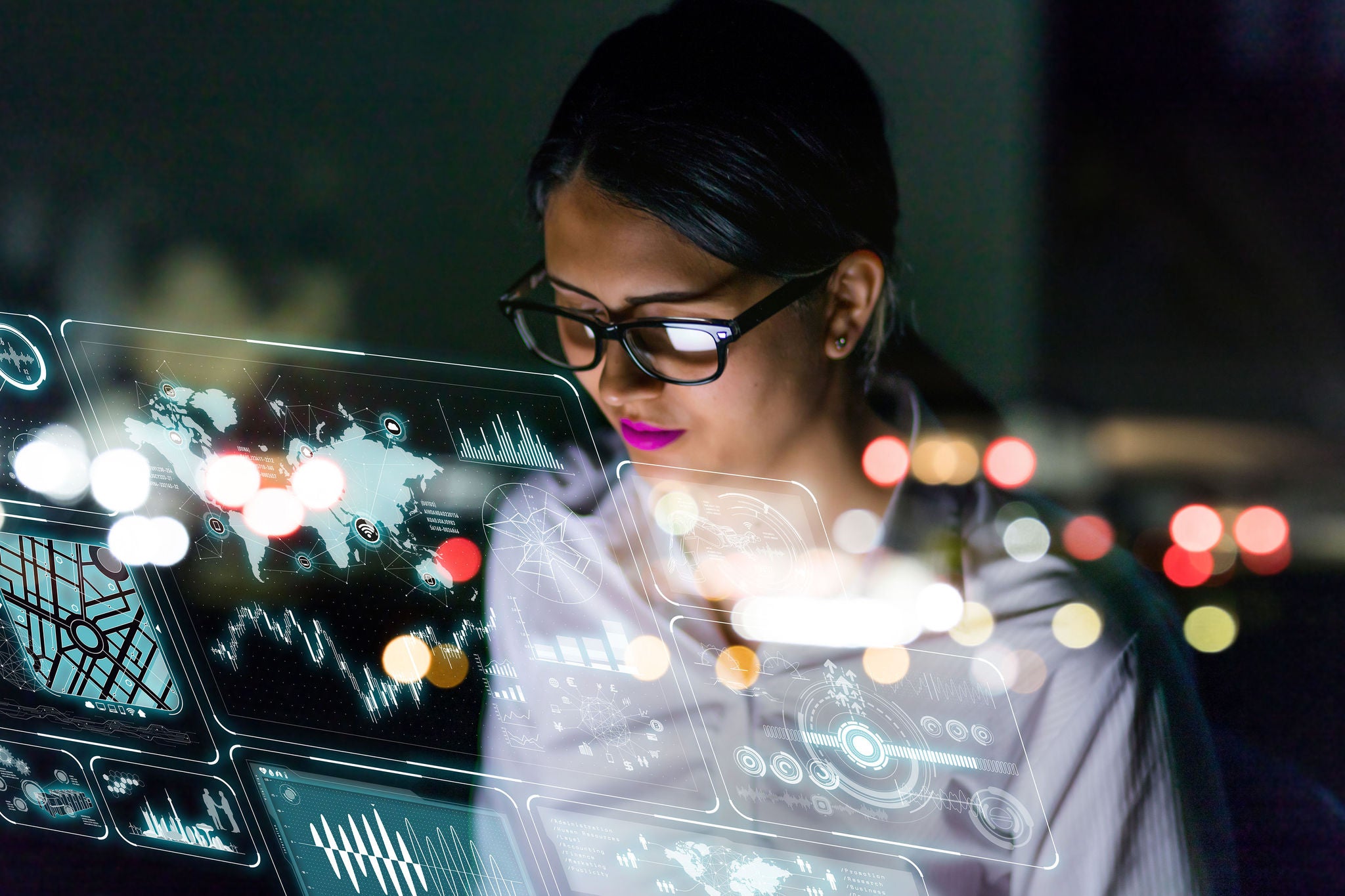 Woman engineer looking at various information in screen of futuristic interface