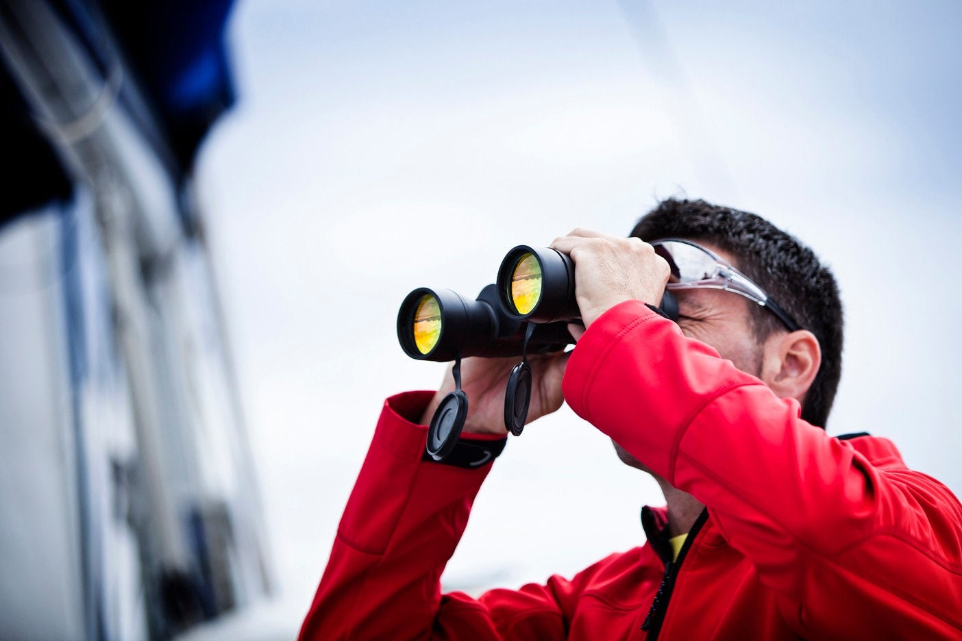 Man using binoculars to watch far view