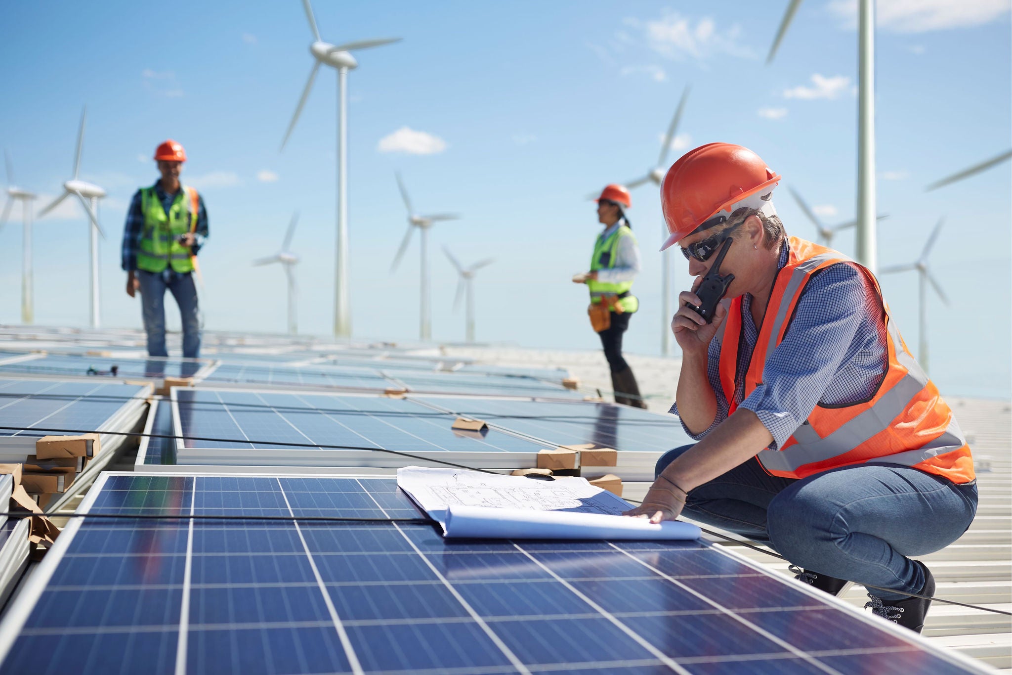 Engineers at solar pannel and wind power field