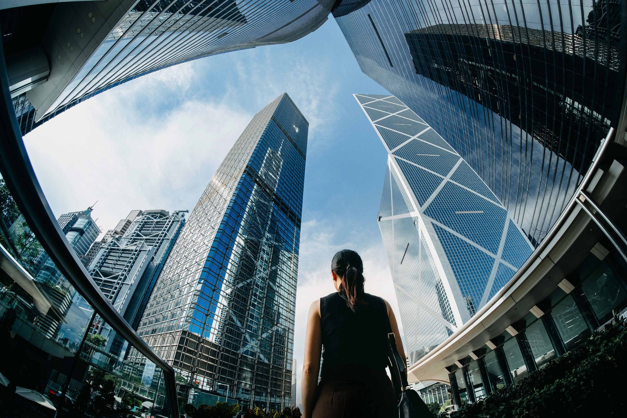 Lady looking at tall building