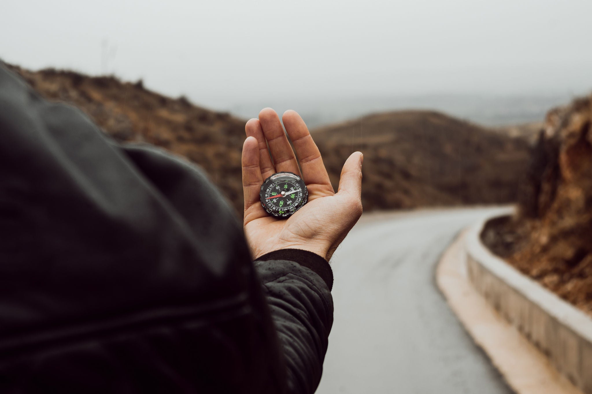 man holding compass