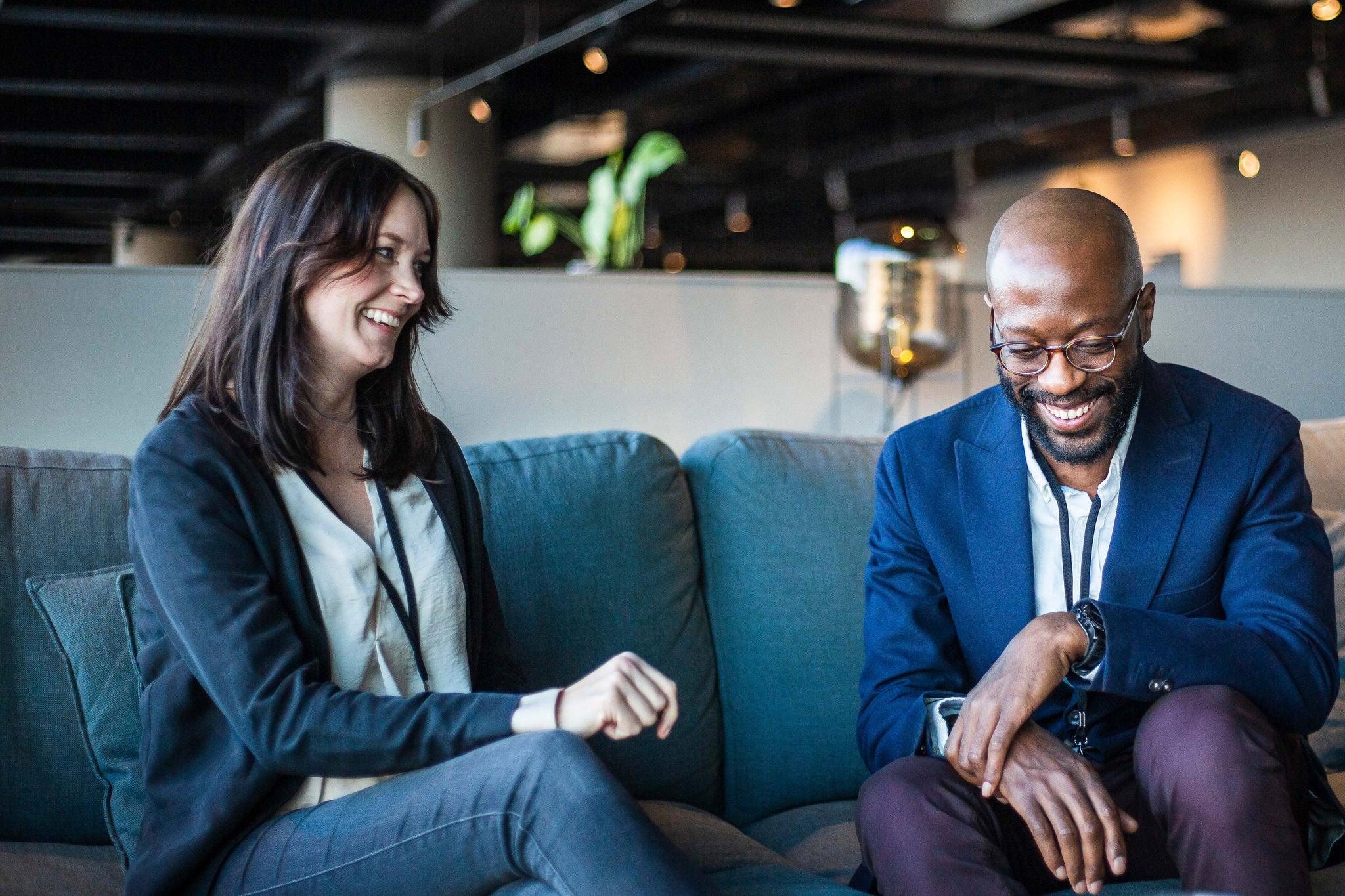 Smiling businessman and businesswoman sitting in office