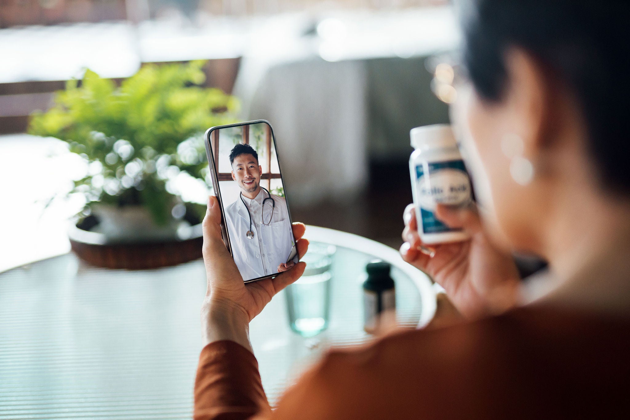 Senior Asian woman having a virtual appointment with doctor online