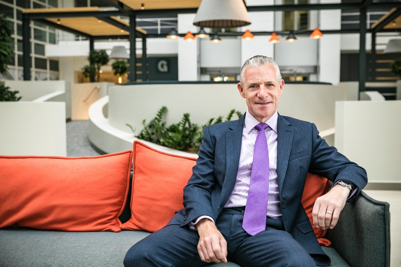 A man sat on a couch in an office