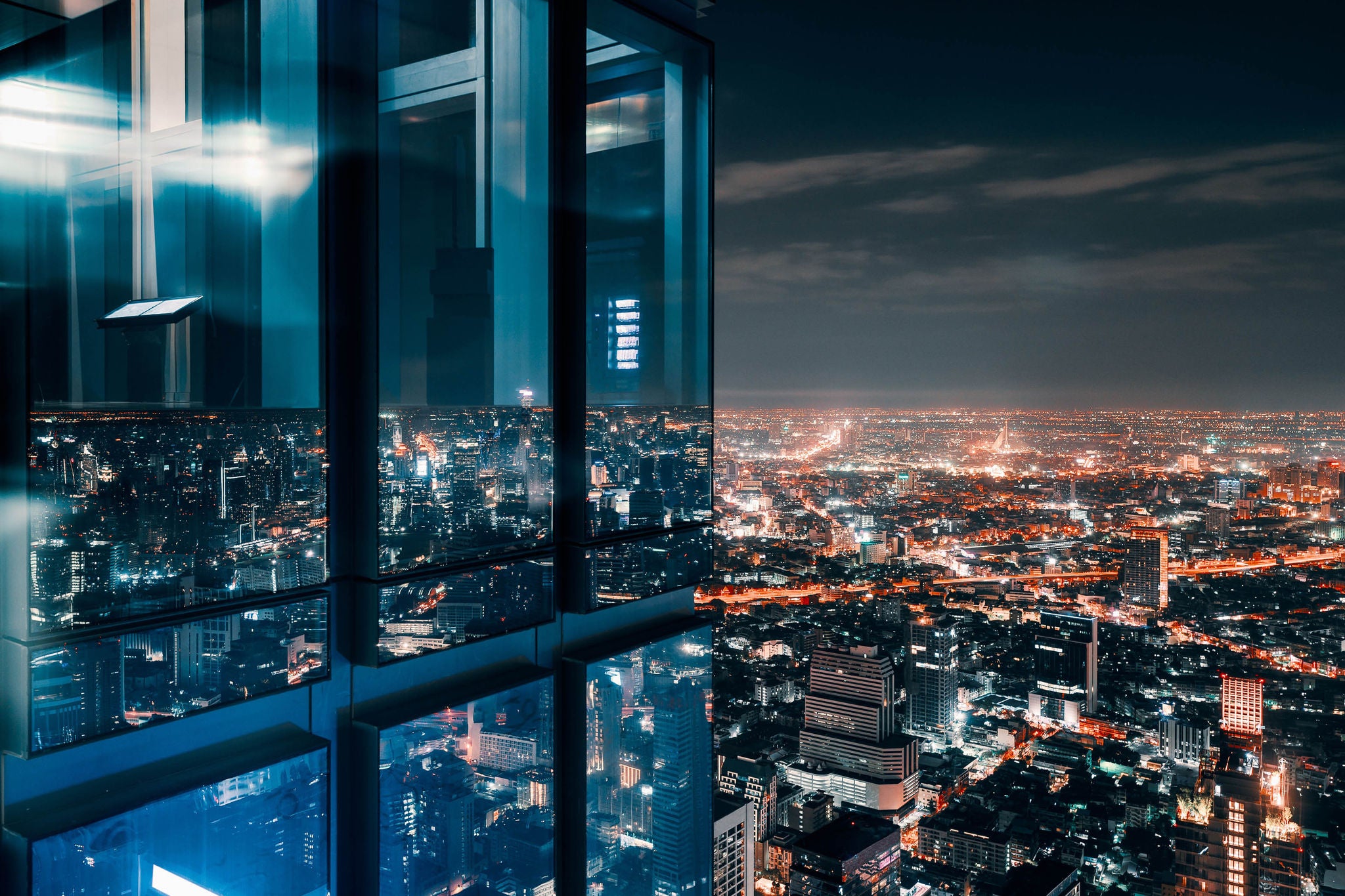 Glass window with glowing crowded city