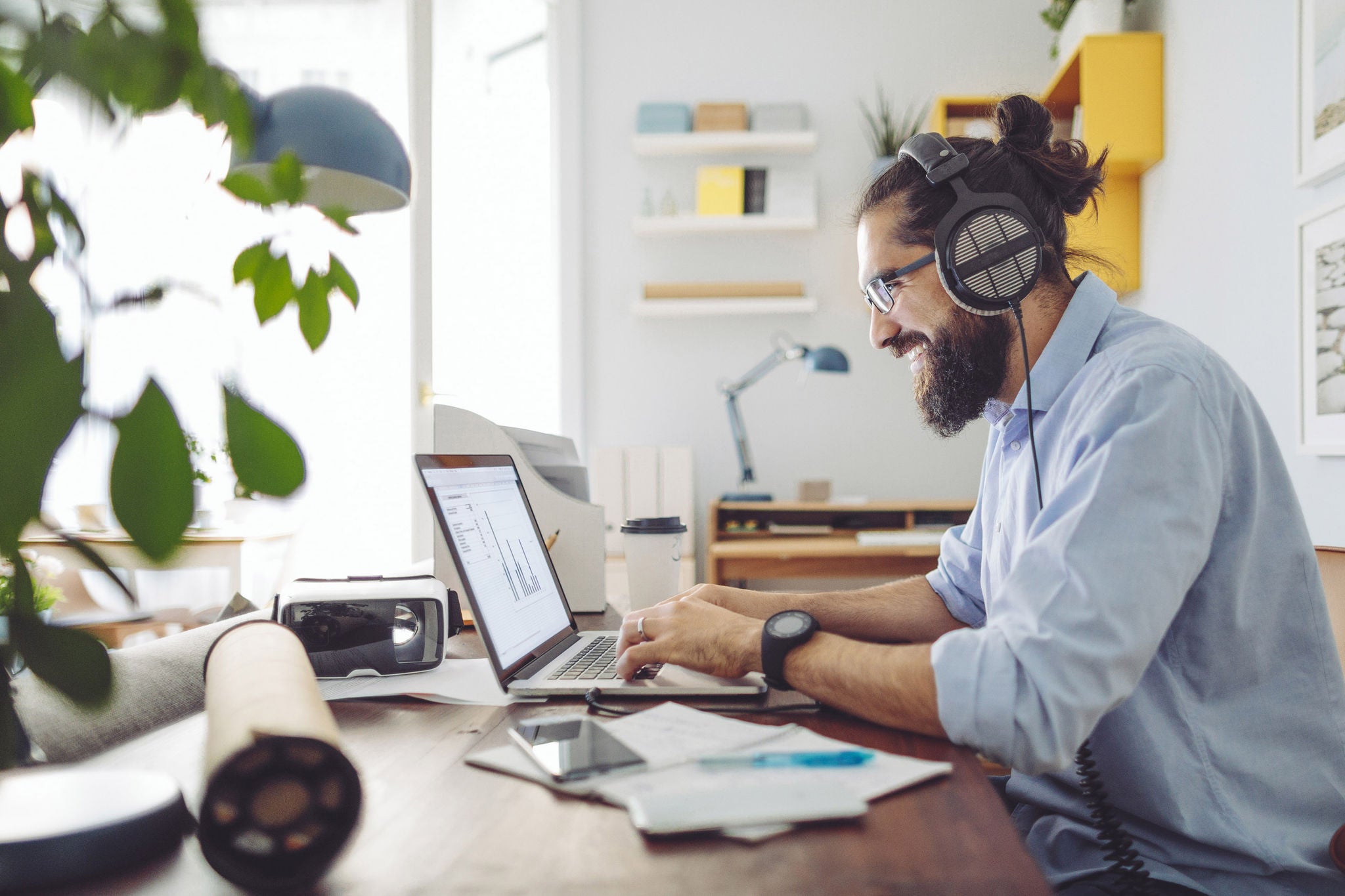 Ey man works on computer at home