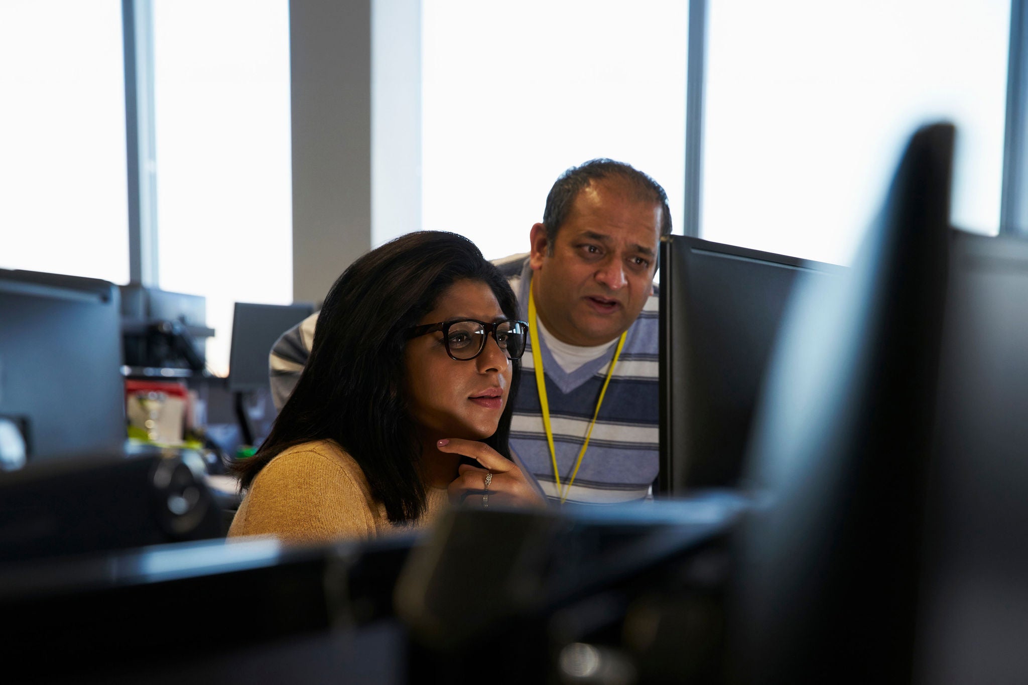 ey business people working at laptop in office