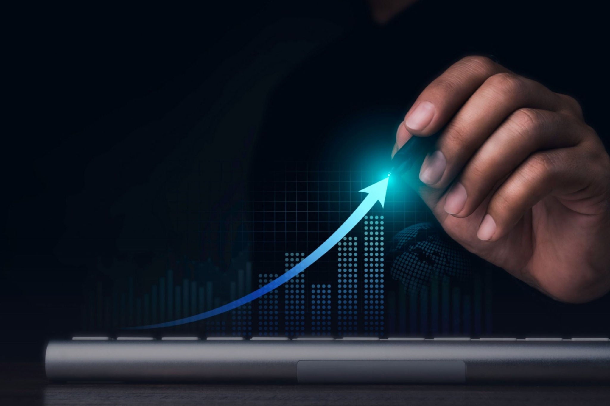 Man's hand holding pen and verifying the digital statistics