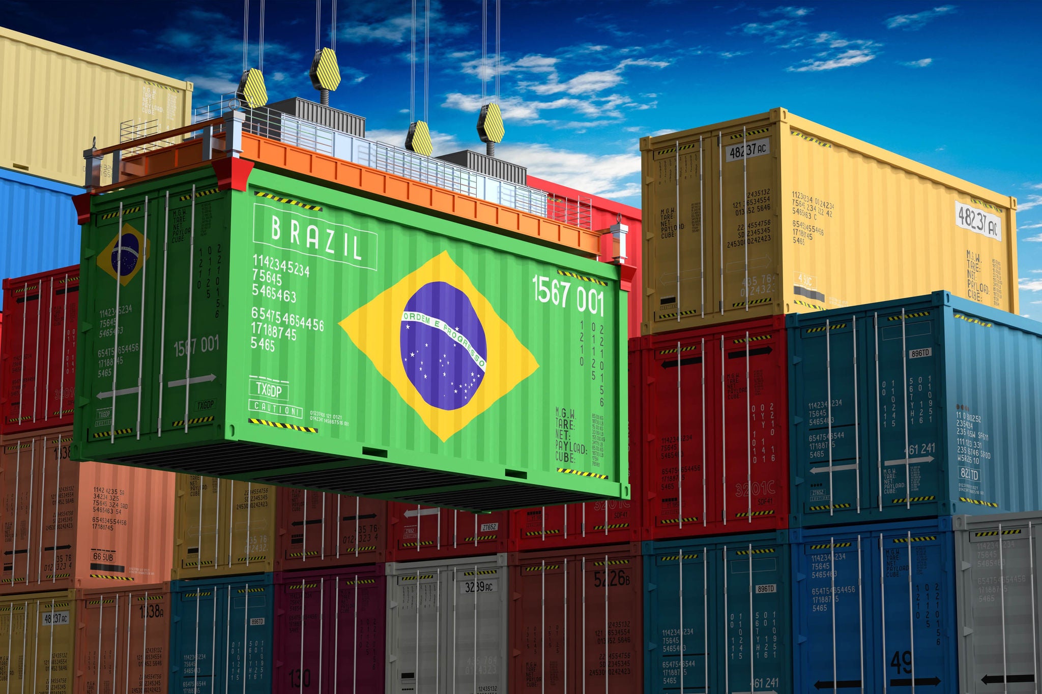 Freight shipping container with flag of Brazil on crane hook