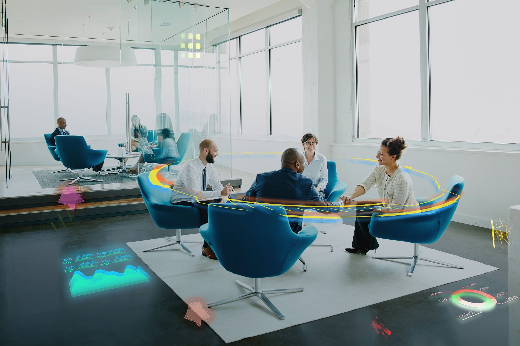 Four people sitting around a table and engaged in a discussion in an office