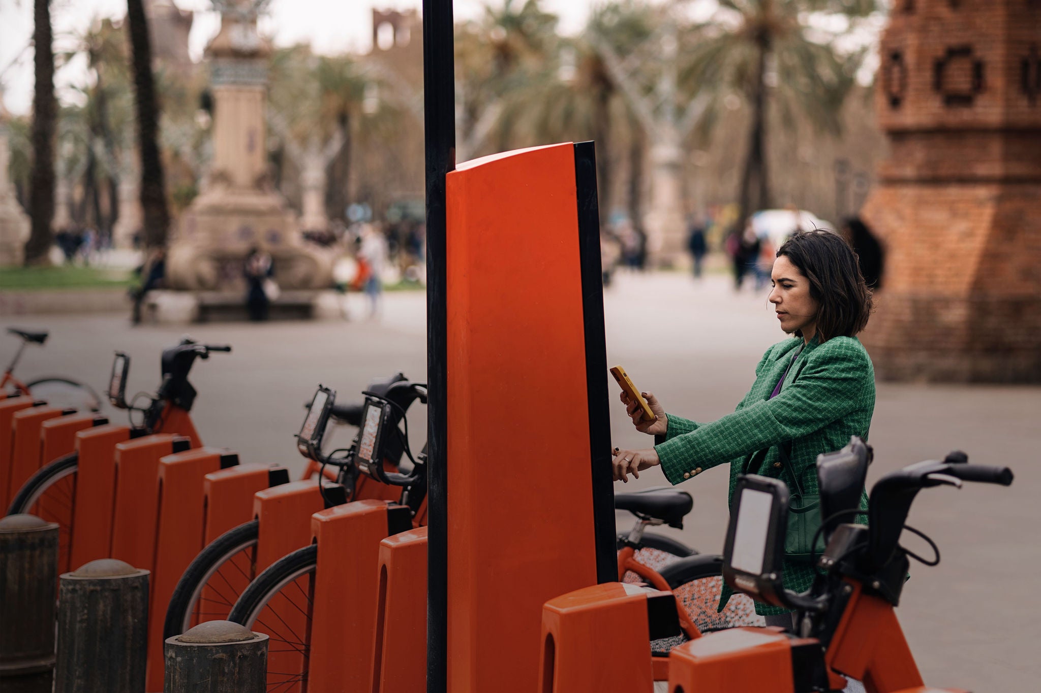 Focused woman paying for bicycle rental