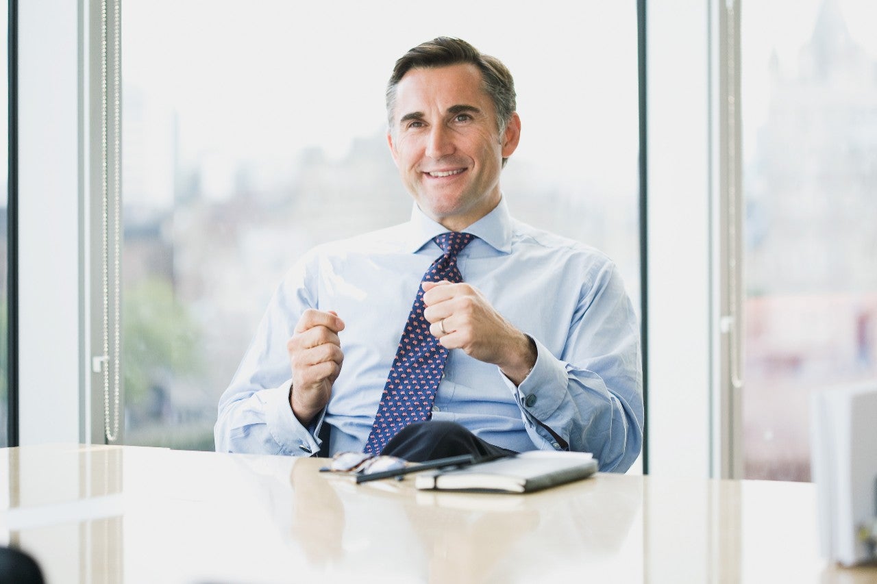 Businessman bicycle talking phone waiting elevator office lobby