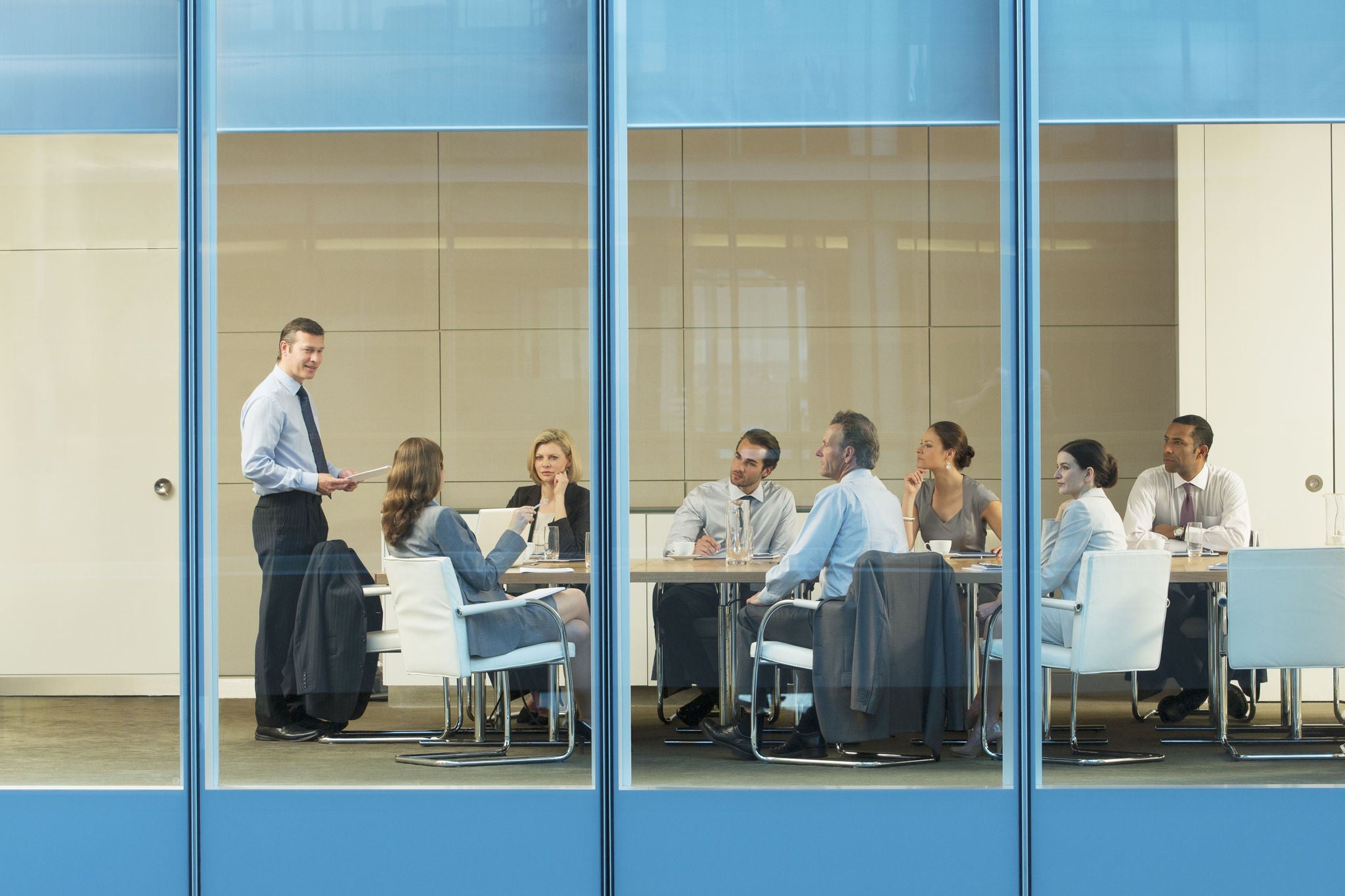 a group meeting behind glasses with blue frames