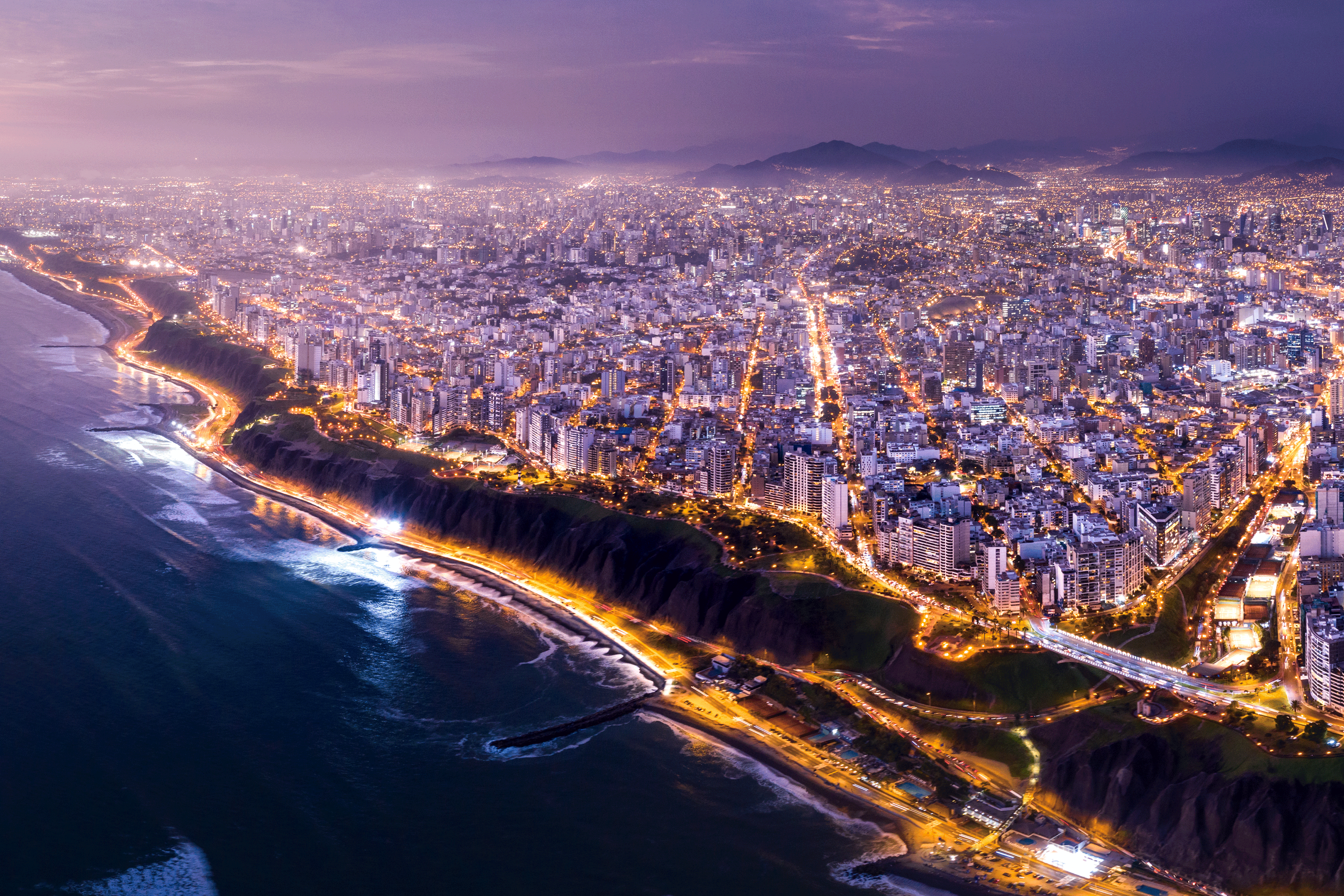 Aerial view of coastal city with night lights