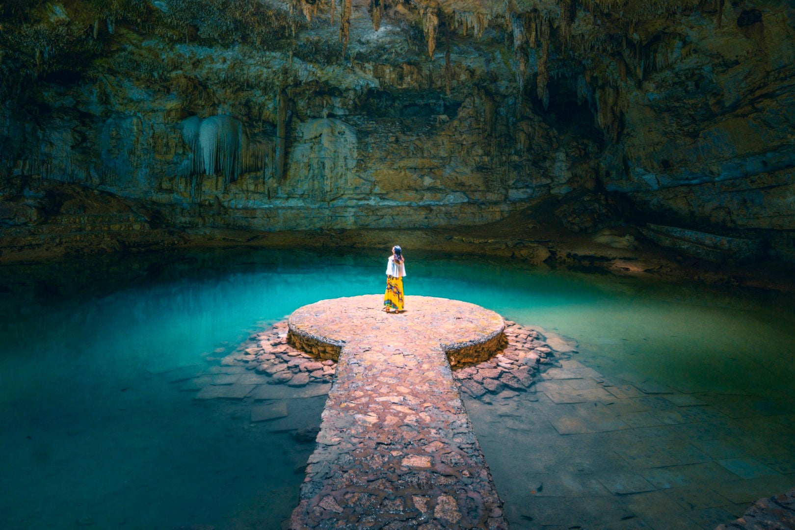 Women standing alone in a cenote in Mexico