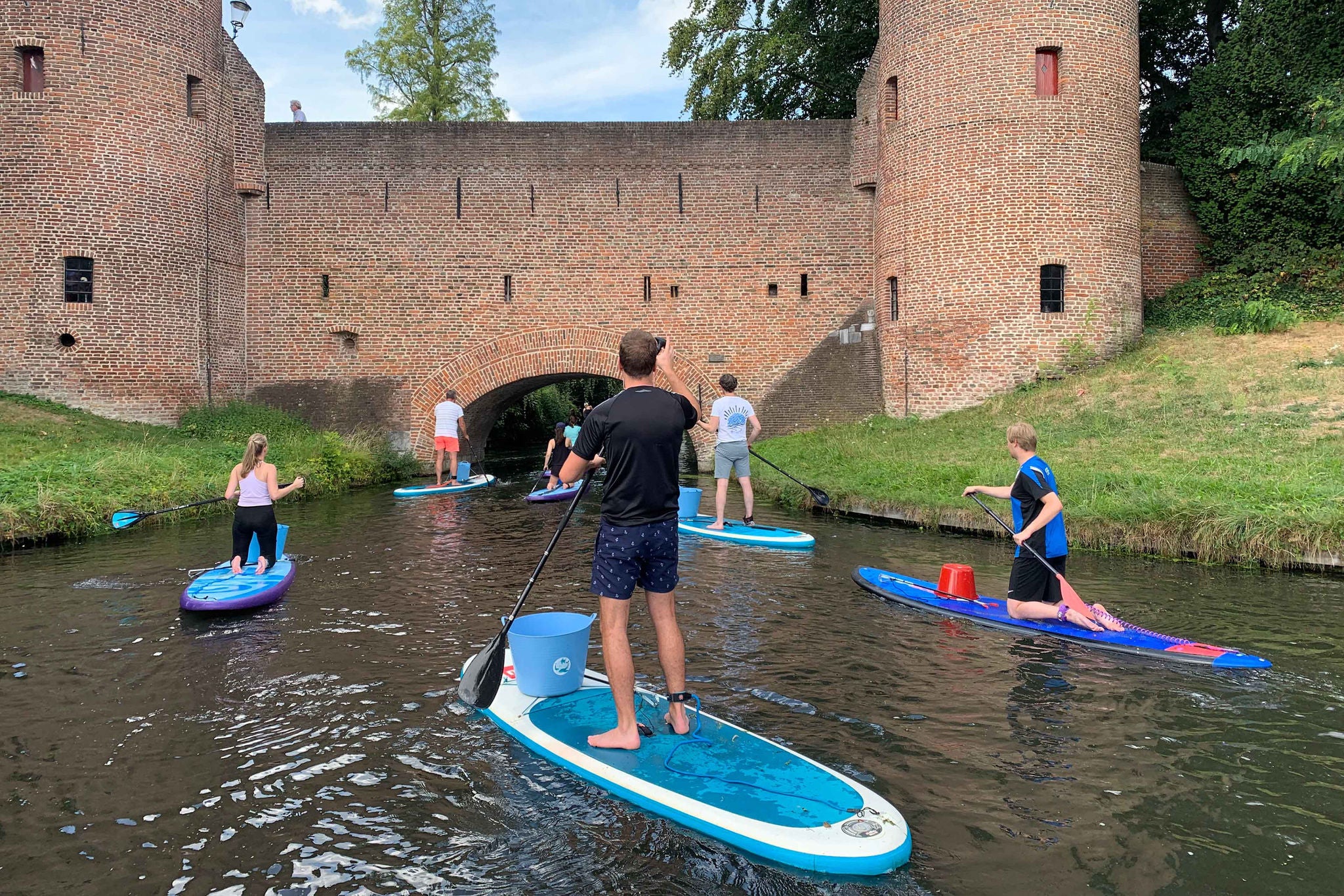 Persons are surfing on river