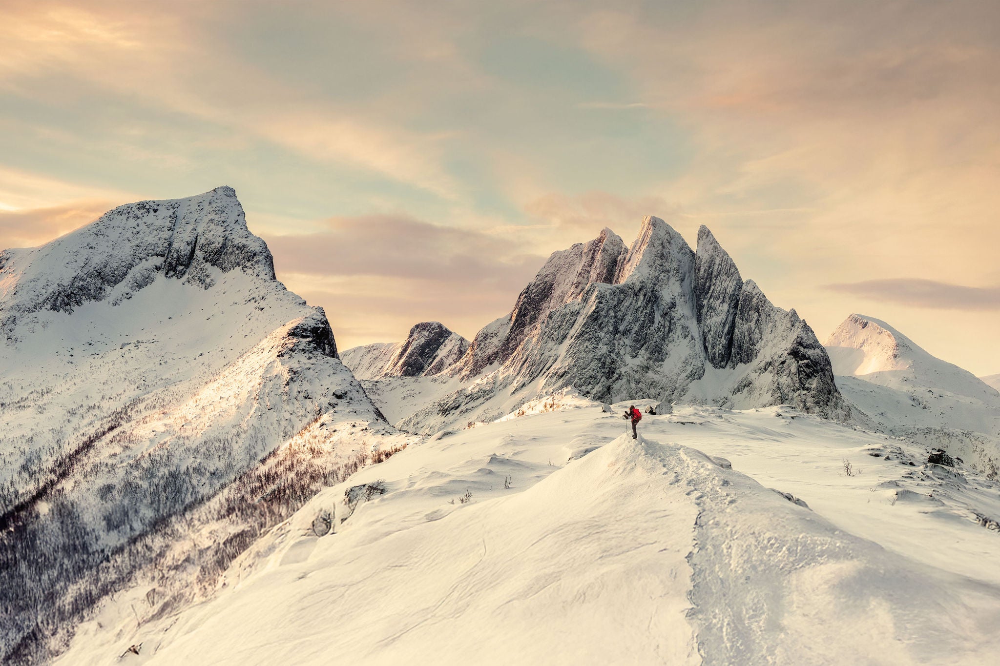 Panorama of Steep peak mountains with covered snow and mountaineer man backpacker stand alone