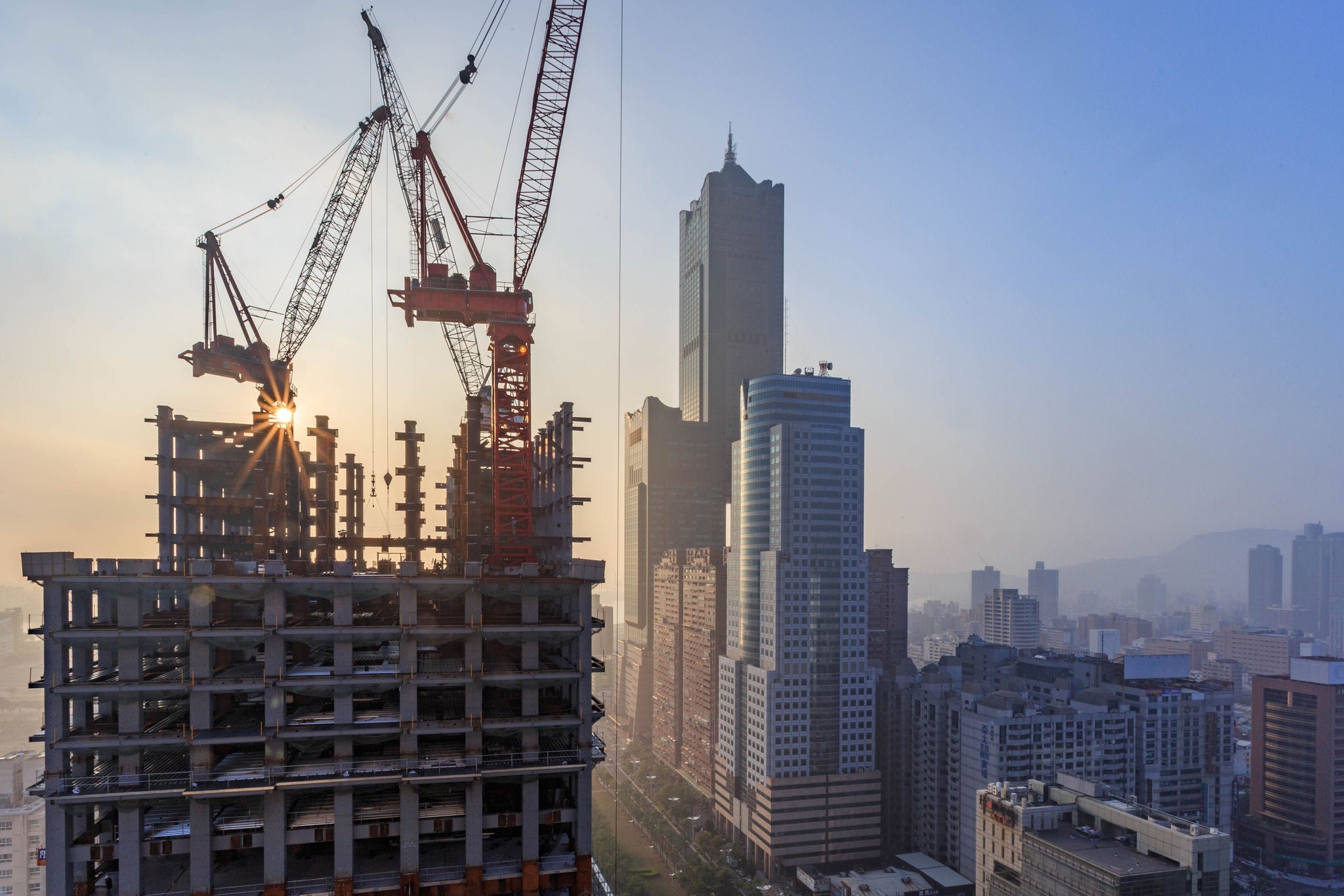 A construction site with several skyscrapers under construction