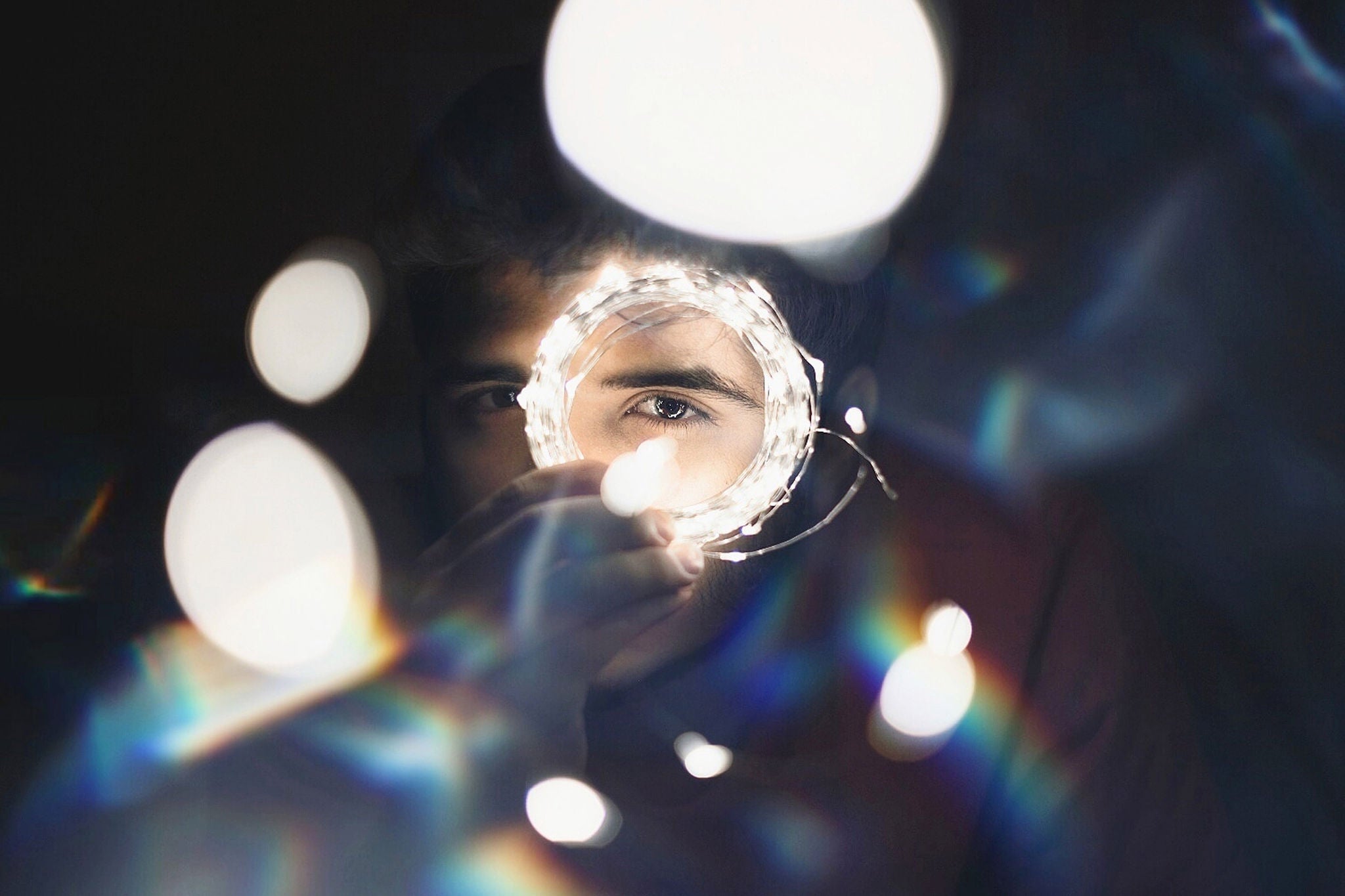 Man looking through ring of lights