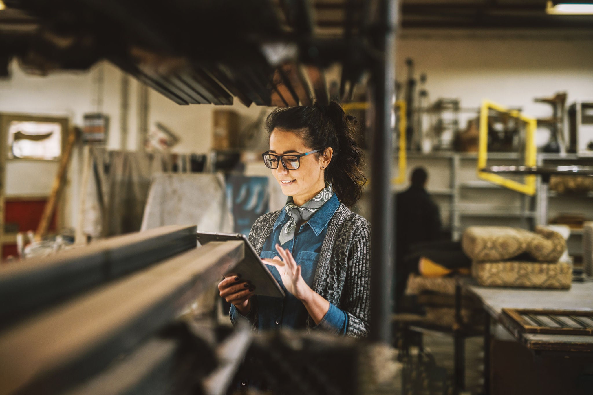 Woman working on a tablet inside a company