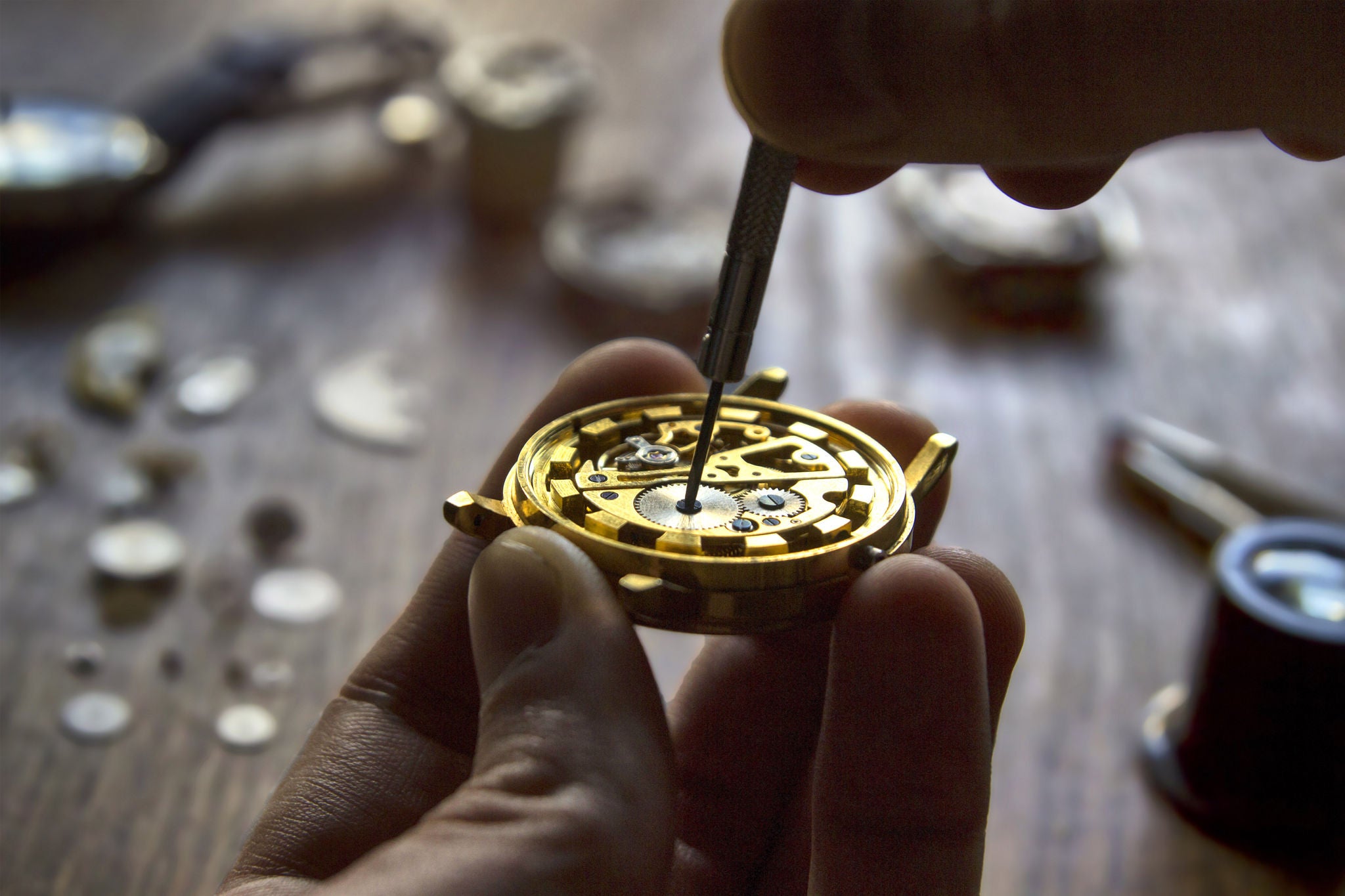 Man repairing watch using repairing tools