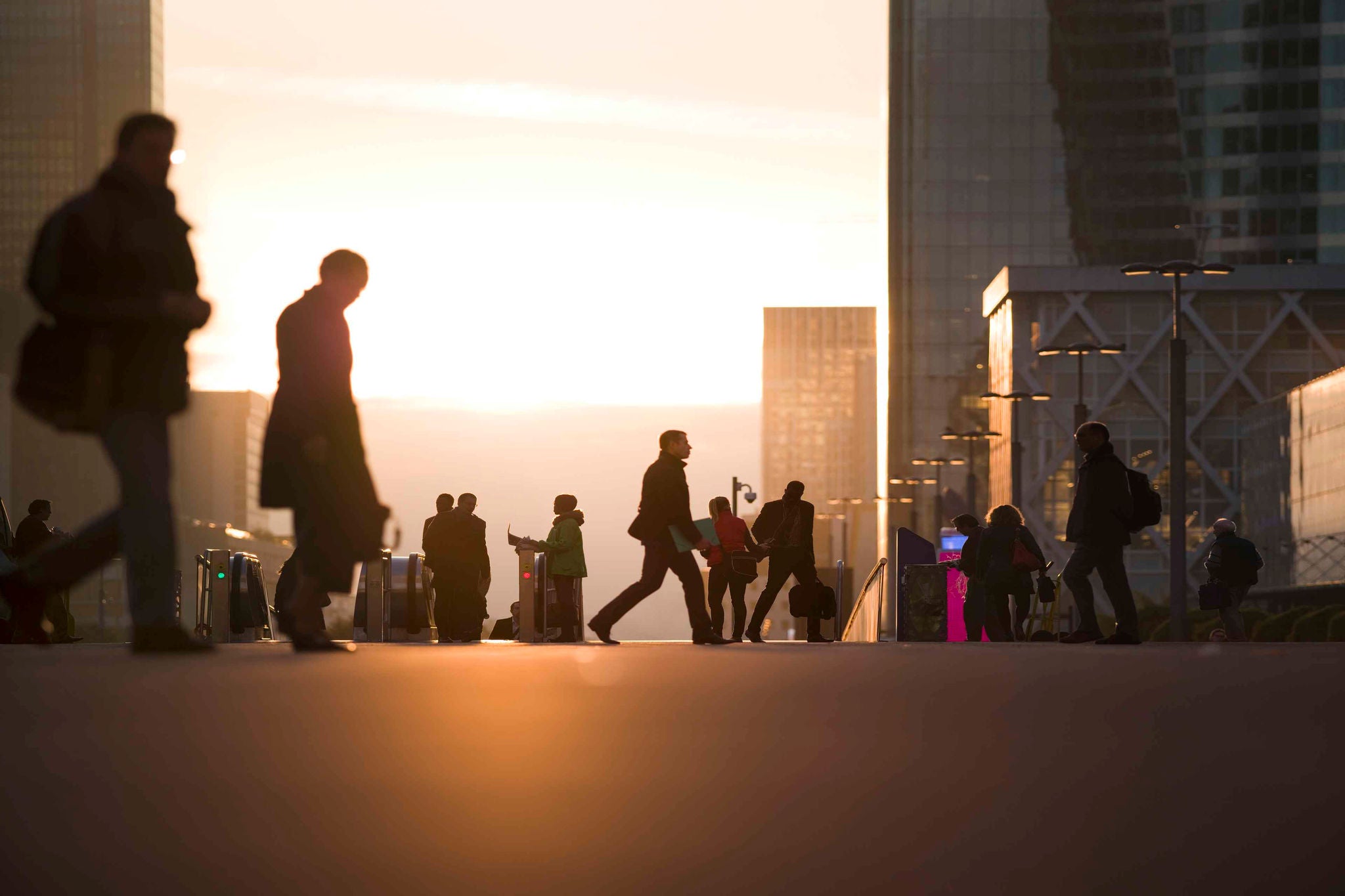 Businesswomen, businessmen and office workers walking to their offices at the business district of Paris.