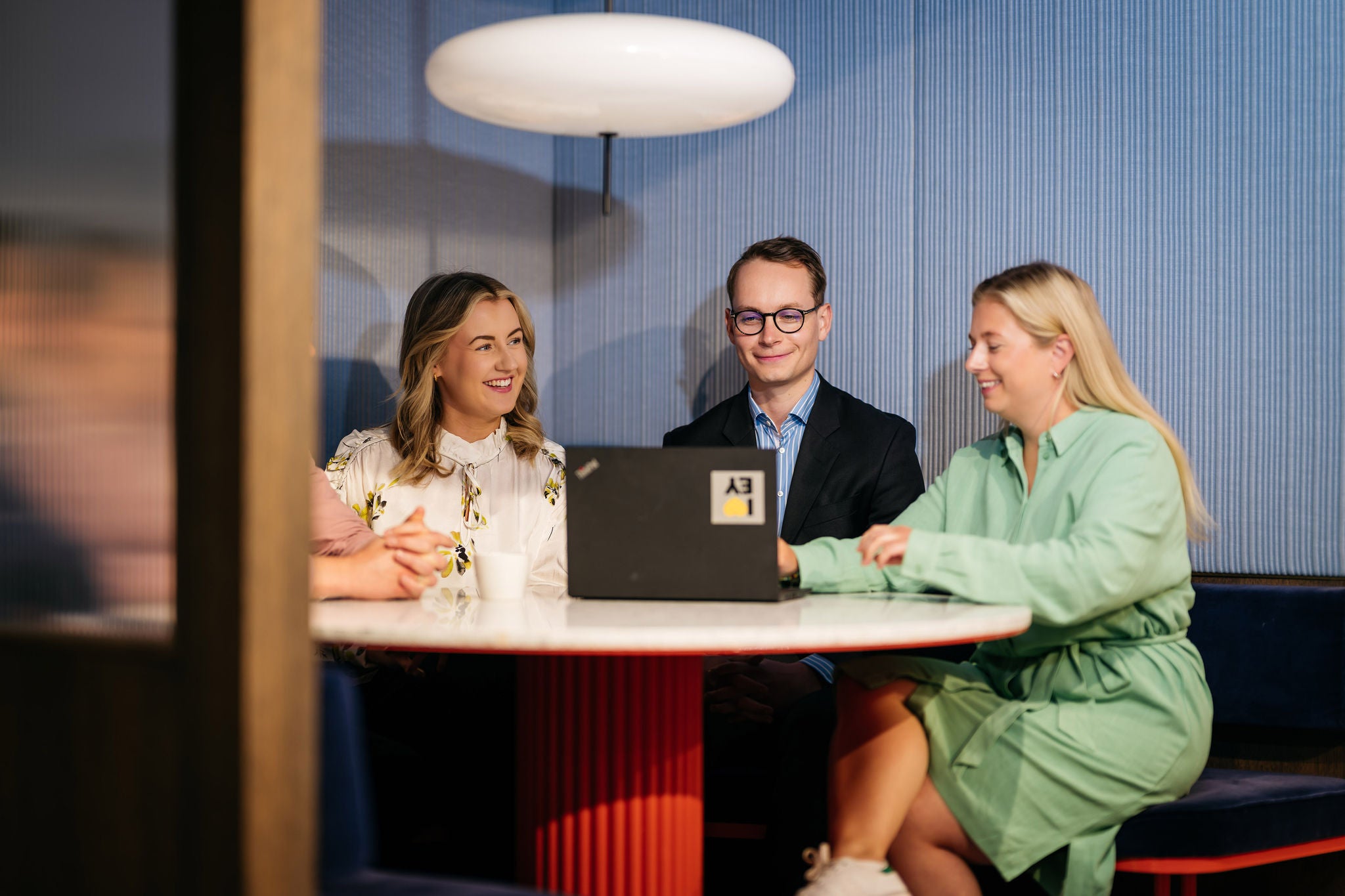 EY Colleagues chatting in work station