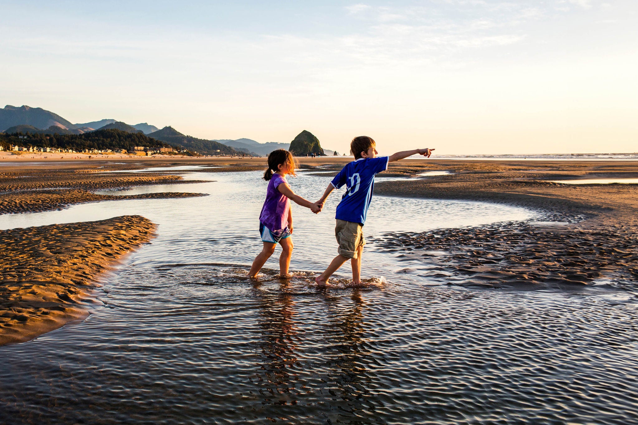 ey-caucasian-children-walking-in-tide-pools-on-beach-background