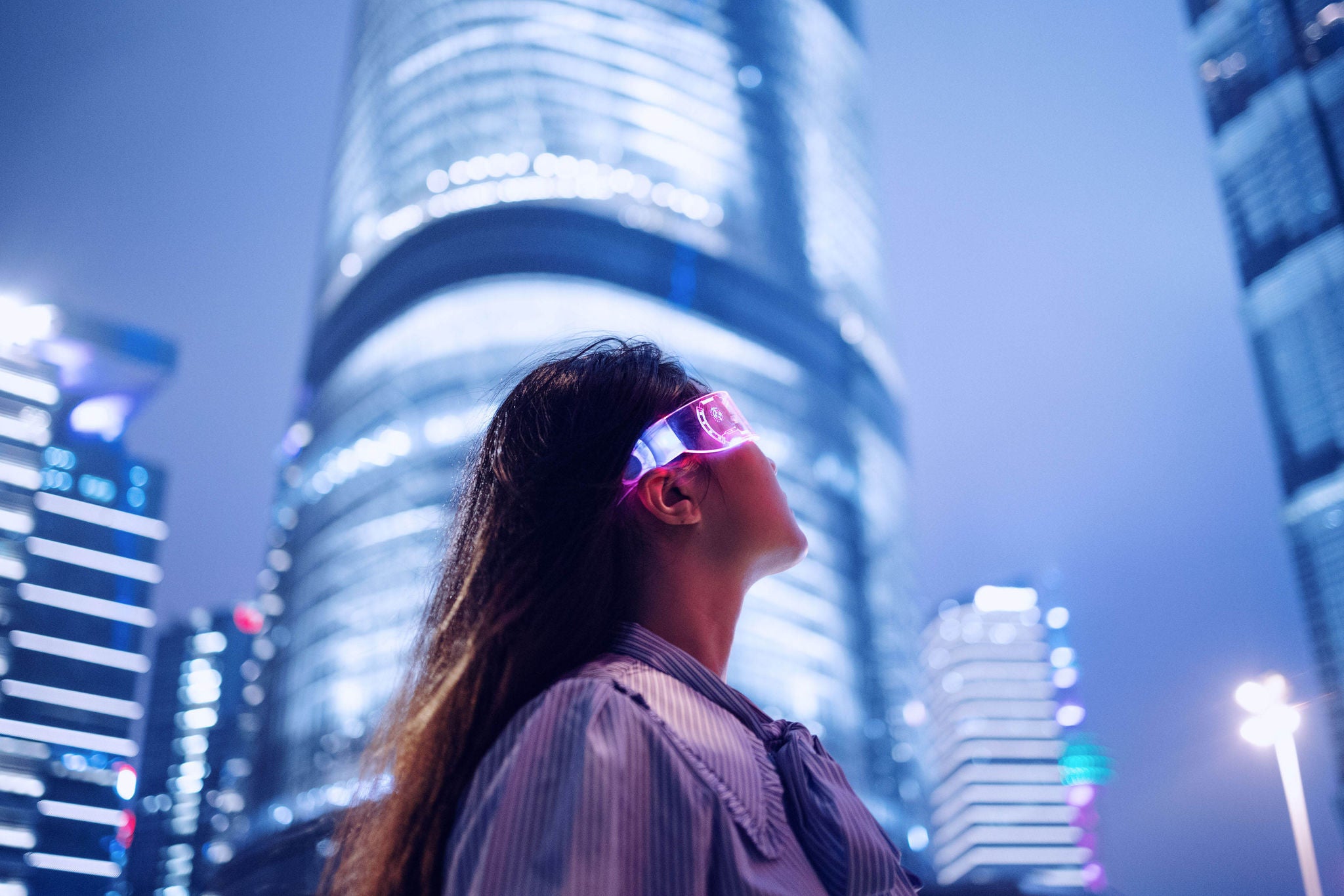 Young businesswoman standing against contemporary financial skyscrapers in the downtown financial district