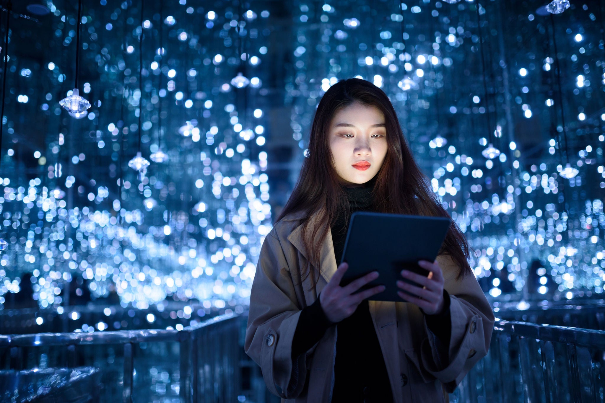  woman using digital tablet against illuminated background