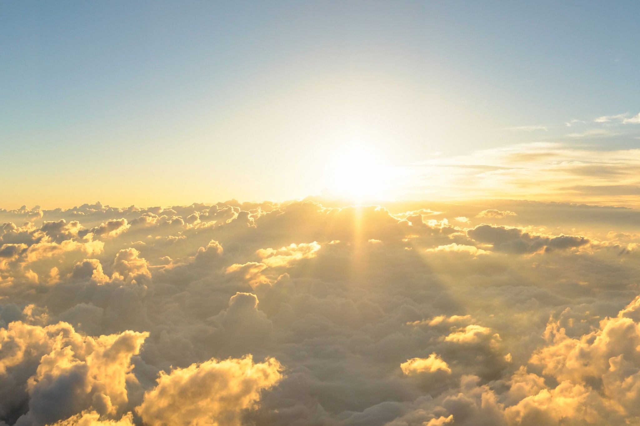 Panorama sunrise from the top of the mount Fuji. The sun is shining strong from the horizon over all the clouds and under the blue sky. good New year new life new beginning. Abstract nature background